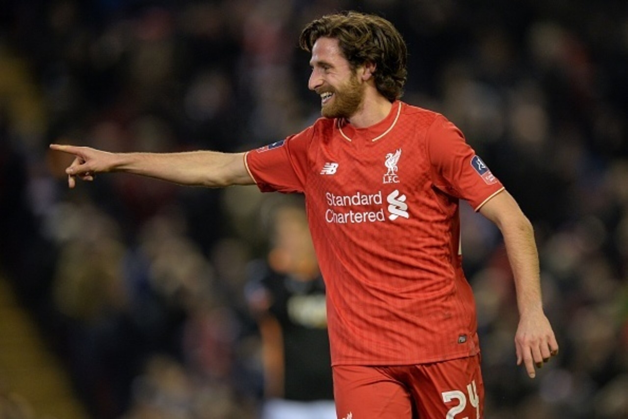Liverpool's Welsh midfielder Joe Allen celebrates after scoring the opening goal of the English FA Cup third round replay football match between Liverpool and Exeter City at Anfield in Liverpool, north west England on January 20, 2016. AFP PHOTO / PAUL EL