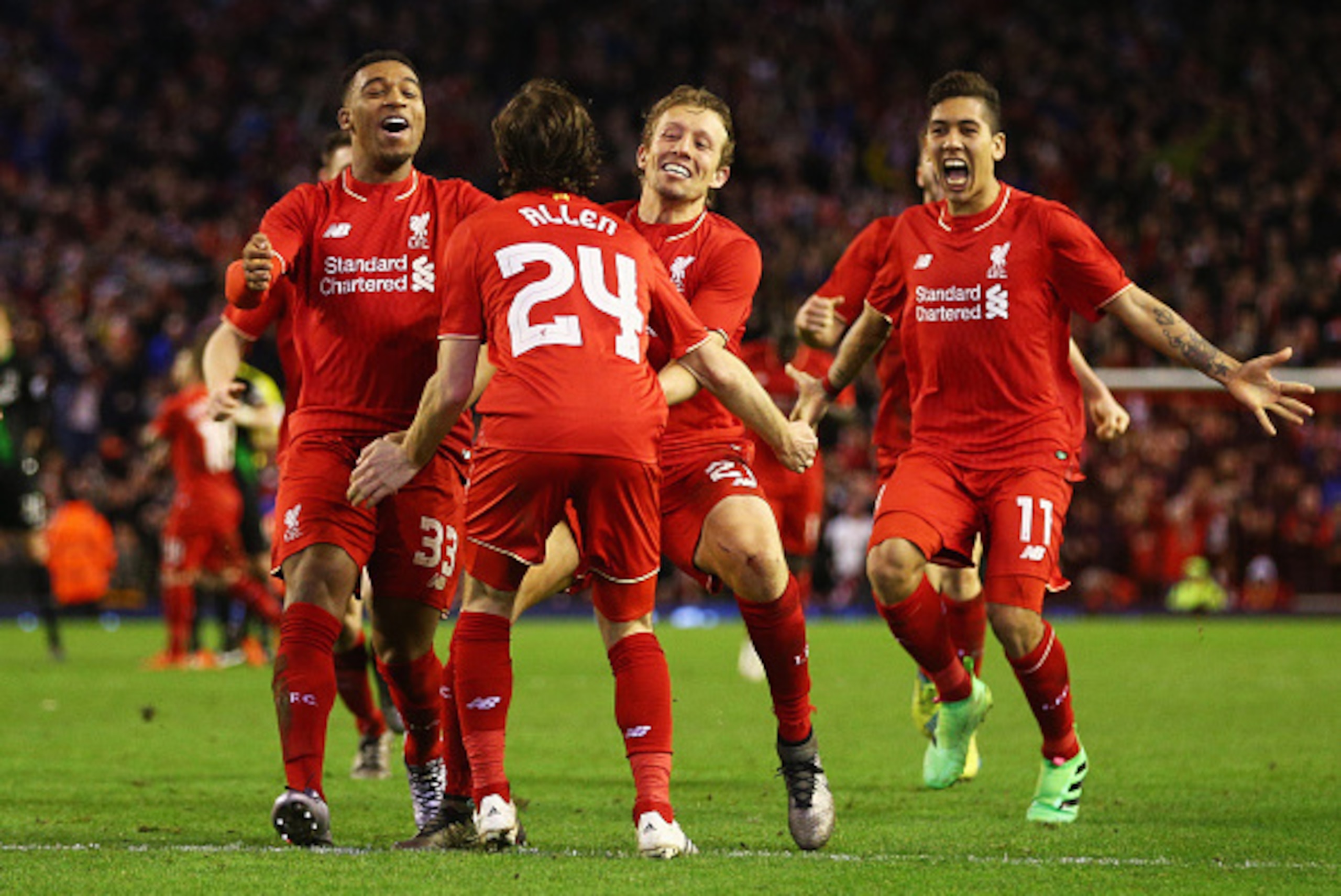 LIVERPOOL, ENGLAND - JANUARY 26:  Joe Allen of Liverpool (24) is congratulated by team mates as he scores the decisive penalty in the shoot out during the Capital One Cup semi final second leg match between Liverpool and Stoke City at Anfield on January 2