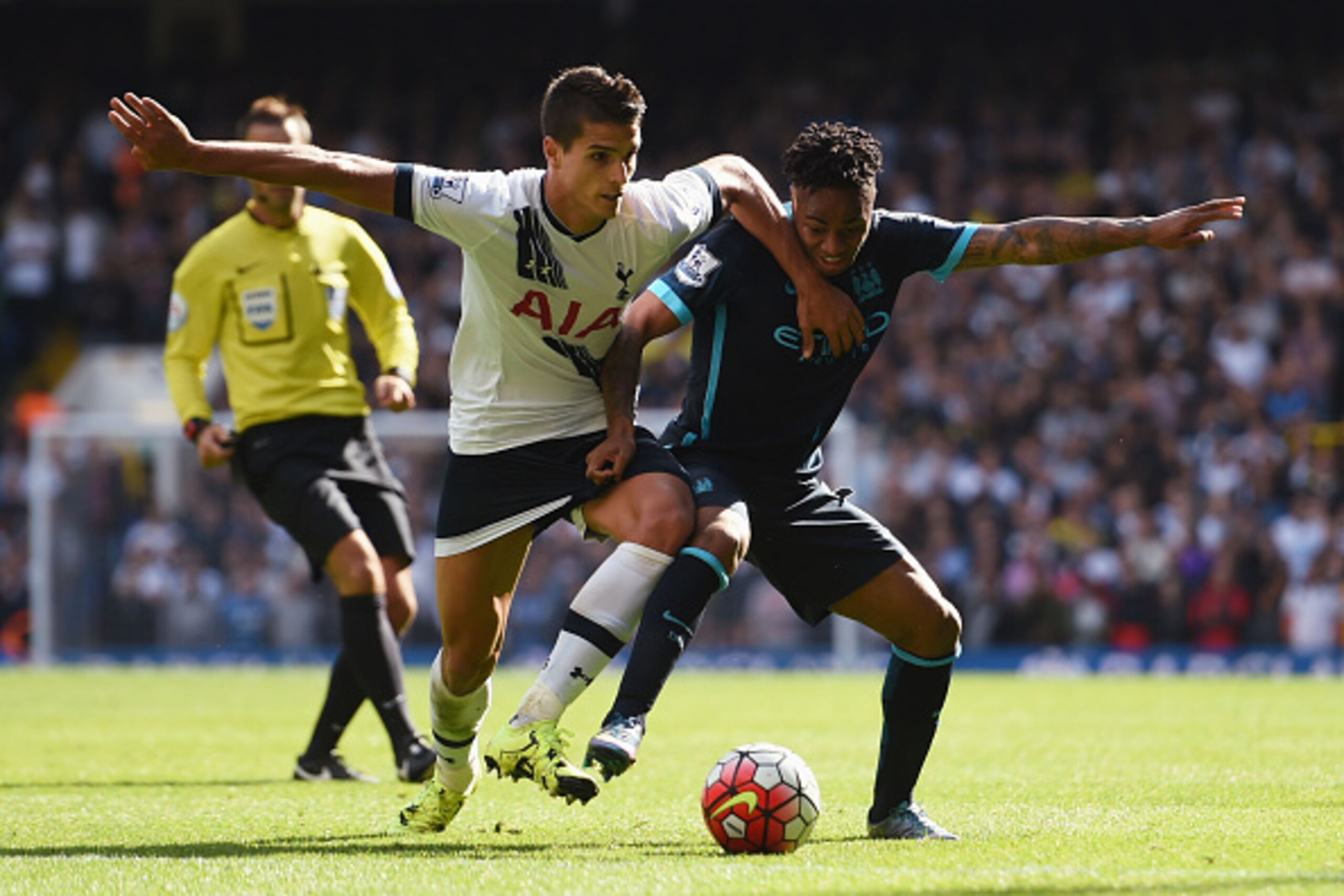 LONDON, ENGLAND - SEPTEMBER 26: Raheem Sterling of Manchester City and Erik Lamela of Tottenham Hotspur compete for the ball during the Barclays Premier League match between Tottenham Hotspur and Manchester City at White Hart Lane on September 26, 2015 in LONDON, ENGLAND - SEPTEMBER 26: Raheem Sterling of Manchester City and Erik Lamela of Tottenham Hotspur compete for the ball during the Barclays Premier League match between Tottenham Hotspur and Manchester City at White Hart Lane on September 26, 2015 in
