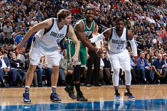 DALLAS, TX - JANUARY 18: Dirk Nowitzki #41 and Wesley Matthews #23 of the Dallas Mavericks box out Jae Crowder #99 of the Boston Celtics during the game on January 18, 2016 at the American Airlines Center in Dallas, Texas. NOTE TO USER: User expressly ack