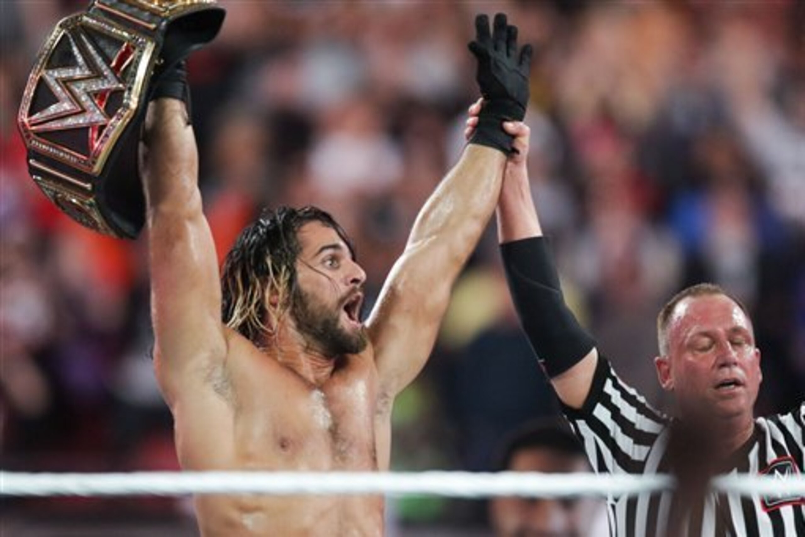 Seth Rollins celebrates his surprise win at WrestleMania 31.