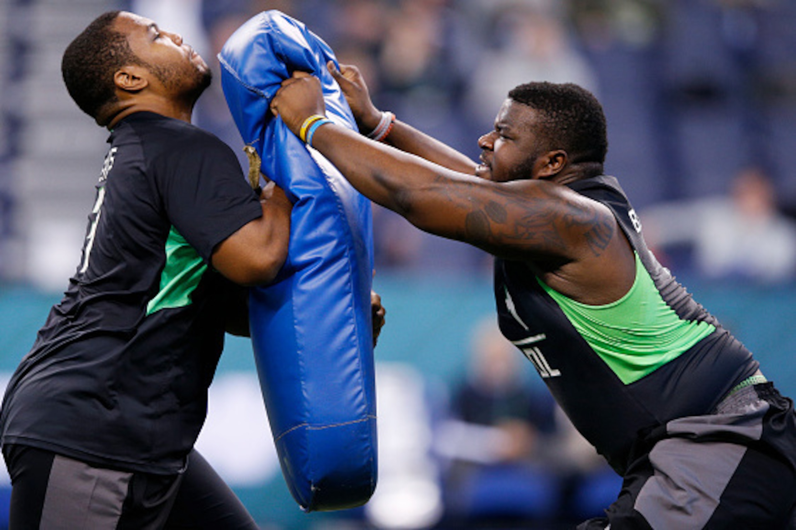 INDIANAPOLIS, IN - FEBRUARY 26: Offensive linemen Willie Beavers #3 of Western Michigan and Caleb Benenoch #4 of UCLA participate in a drill during the 2016 NFL Scouting Combine at Lucas Oil Stadium on February 26, 2016 in Indianapolis, Indiana. (Photo by INDIANAPOLIS, IN - FEBRUARY 26: Offensive linemen Willie Beavers #3 of Western Michigan and Caleb Benenoch #4 of UCLA participate in a drill during the 2016 NFL Scouting Combine at Lucas Oil Stadium on February 26, 2016 in Indianapolis, Indiana. (Photo by