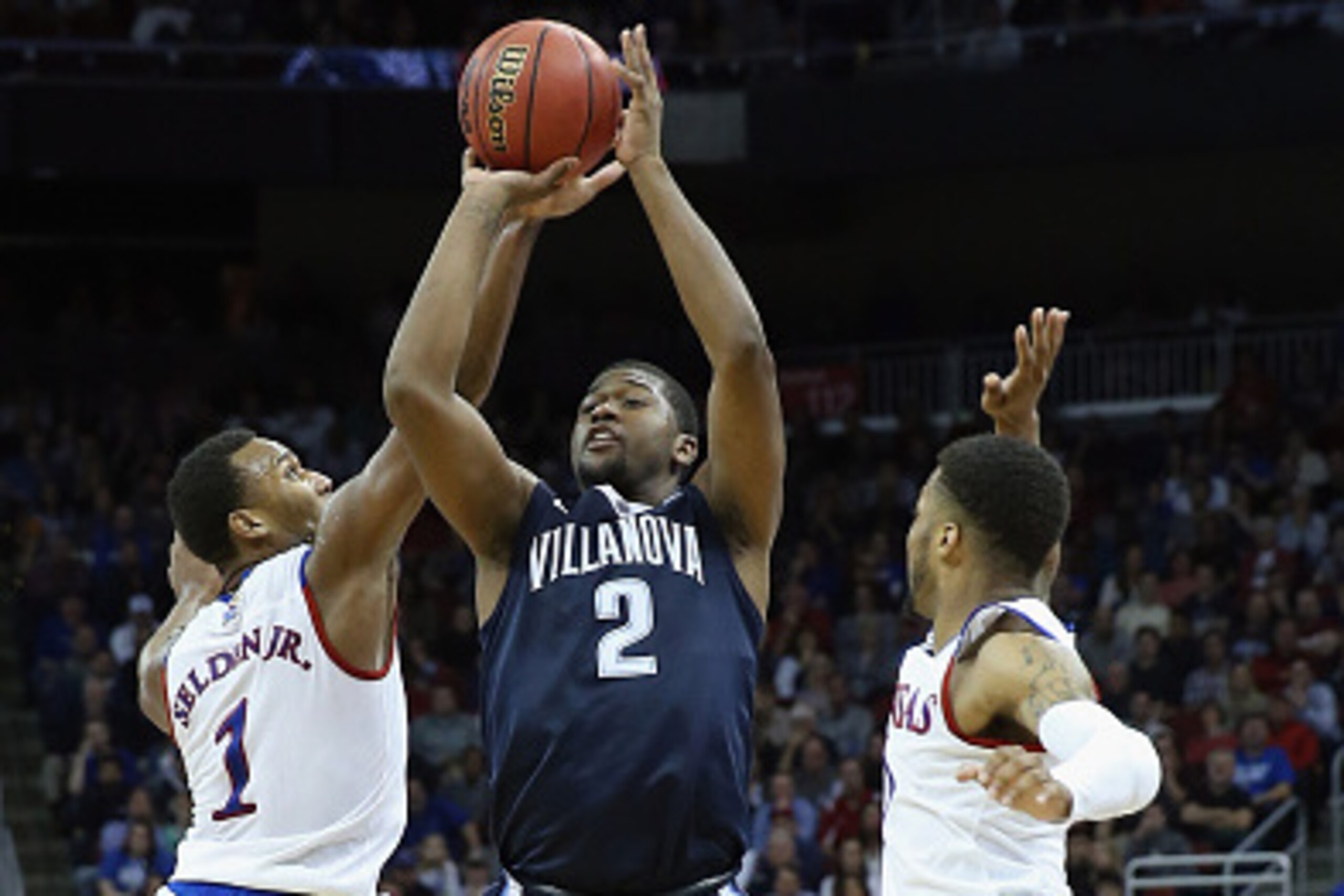 LOUISVILLE, KY - MARCH 26:  Kris Jenkins #2 of the Villanova Wildcats shoots the ball against Wayne Selden Jr. #1 of the Kansas Jayhawks in the second half during the 2016 NCAA Men's Basketball Tournament South Regional at KFC YUM! Center on March 26, 201