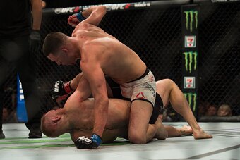 LAS VEGAS, NV - MARCH 5:   Nate Diaz (top) punches Conor McGregor in their welterweight bout during the UFC 196 in the MGM Grand Garden Arena on March 5, 2016 in Las Vegas, Nevada. (Photo by Brandon Magnus/Zuffa LLC/Zuffa LLC via Getty Images)