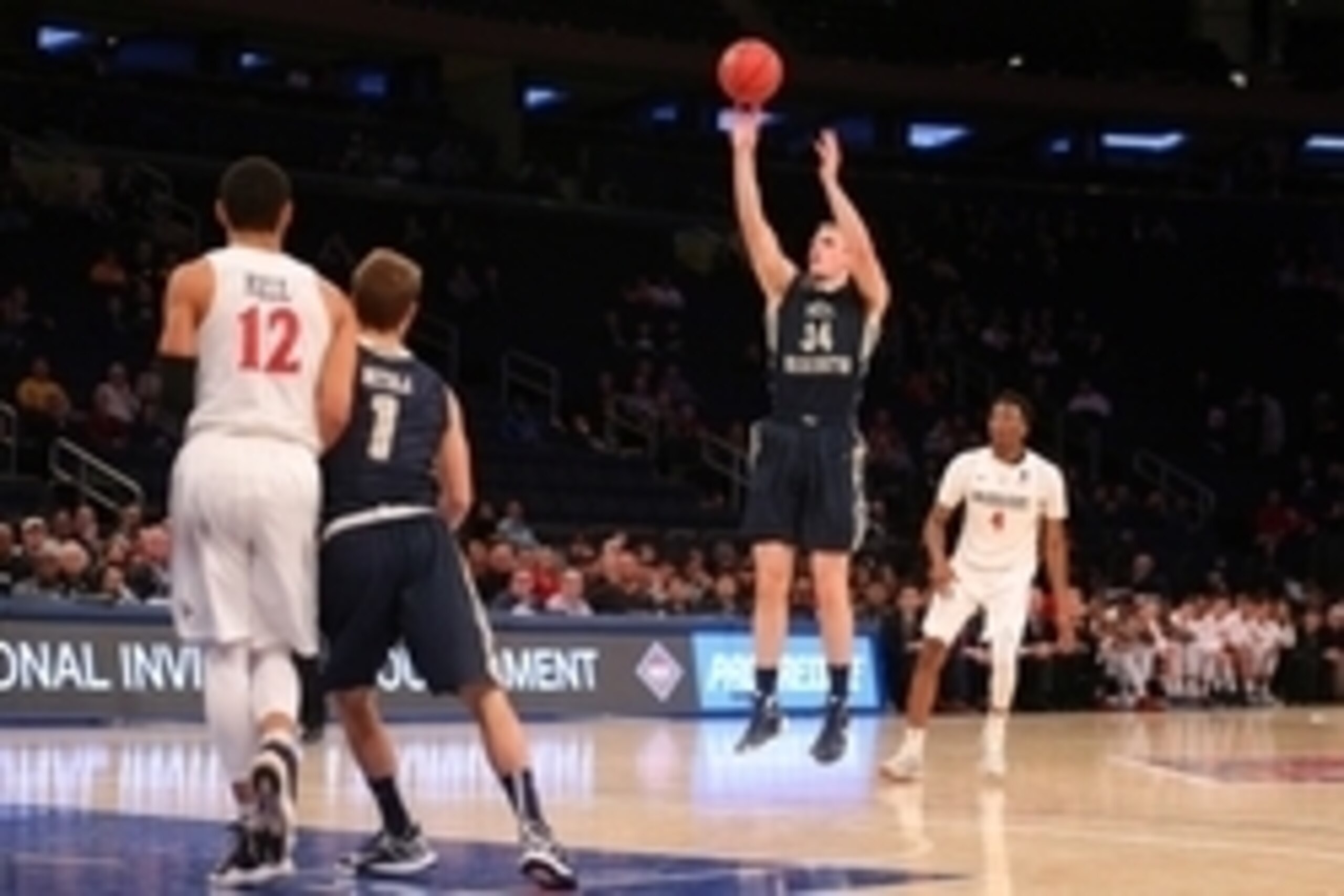 Mar 29, 2016; New York, NY, USA; George Washington Colonials forward Tyler Cavanaugh (34) shoots a three point shot against San Diego State Aztecs guard Dakarai Allen (4) during the second half of a semifinal game of the 2016 NIT basketball tournament at 