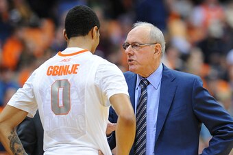 SYRACUSE, NY - JANUARY 13:  Head coach Jim Boeheim of the Syracuse Orange talks with Michael Gbinije #0 during the second half against the Wake Forest Demon Deacons at the Carrier Dome on January 13, 2015 in Syracuse, New York.  Syracuse defeated Wake For