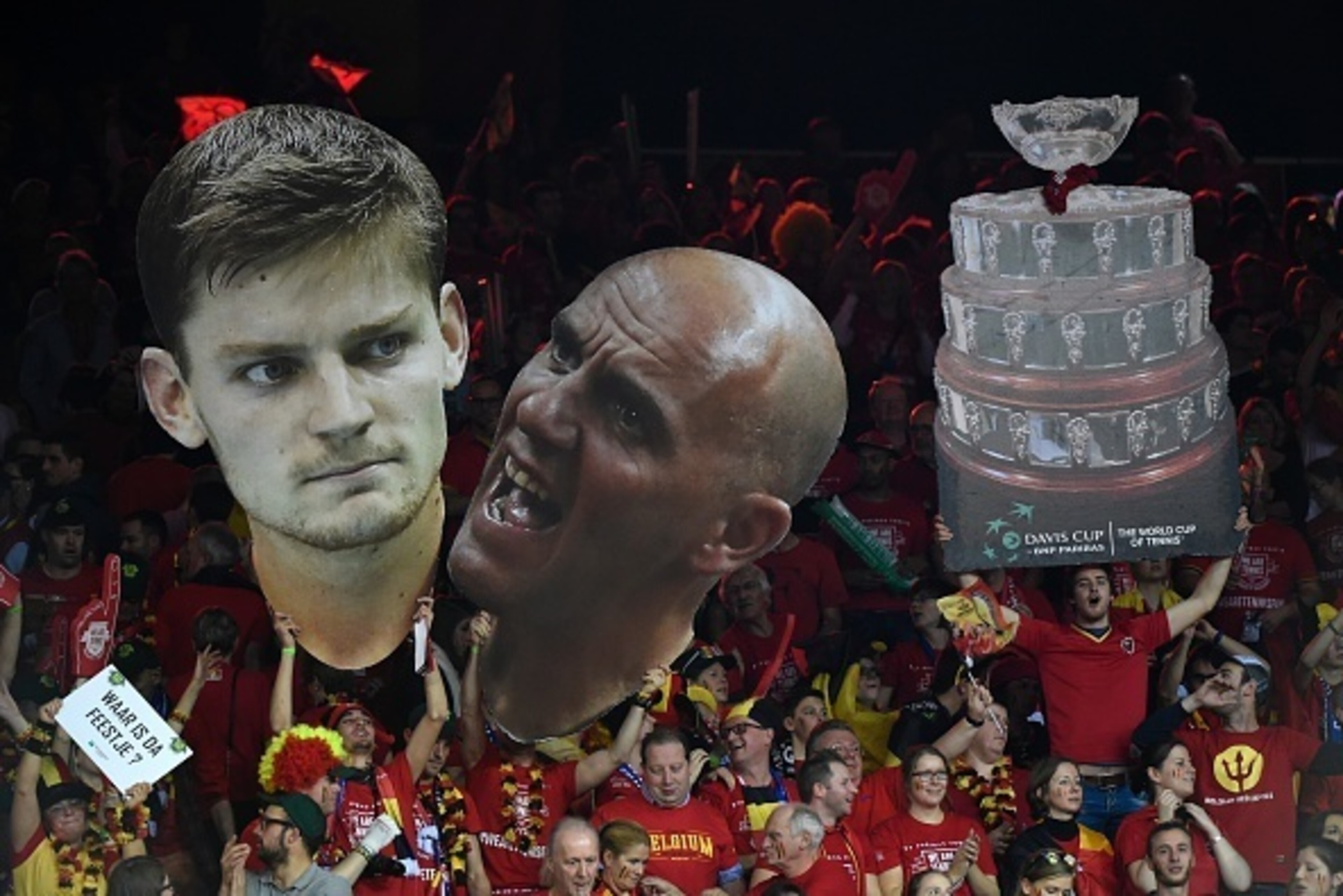 Belgium fans hold up giant portraits of Belgium's David Goffin (L) and Belgium's captain Johan van Herck during the tennis match between Goffin and Britain's Andy Murray on the third day of the Davis Cup final between Belgium and Britain at Flanders Expo 
