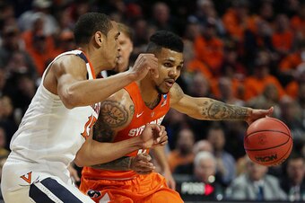 CHICAGO, IL - MARCH 27:  Michael Gbinije #0 of the Syracuse Orange drives against Malcolm Brogdon #15 of the Virginia Cavaliers in the first half during the 2016 NCAA Men's Basketball Tournament Midwest Regional Final at United Center on March 27, 2016 in