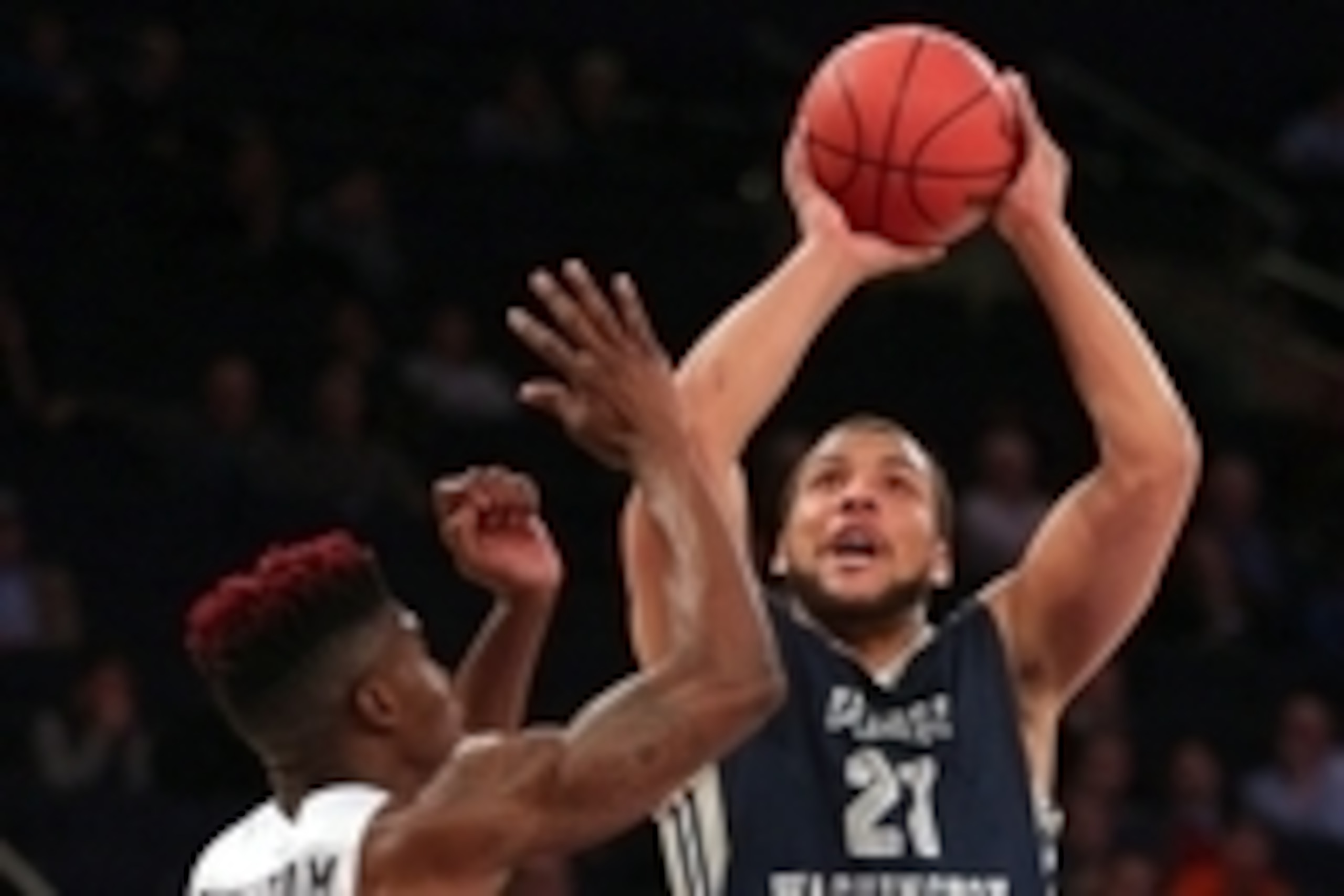 Mar 29, 2016; New York, NY, USA; George Washington Colonials forward Kevin Larsen (21) drives against San Diego State Aztecs forward Zylan Cheatham (14) during the second half of a semifinal game of the 2016 NIT basketball tournament at Madison Square Gar