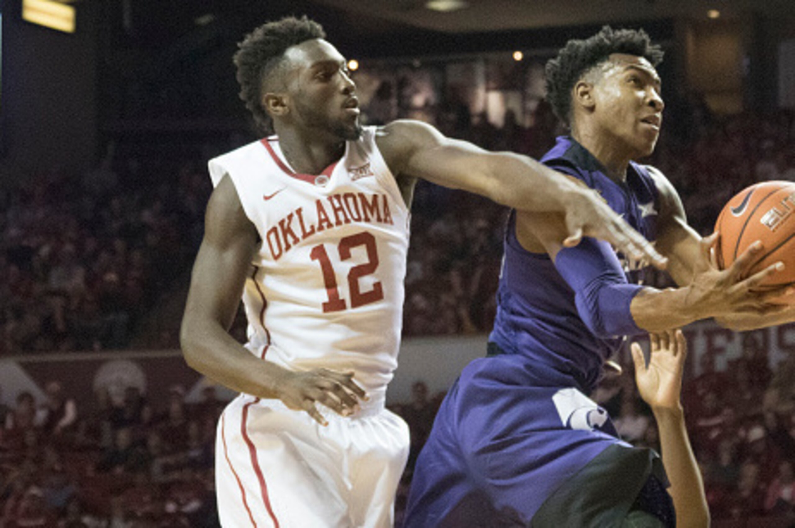 NORMAN, OK - JANUARY 9: Khadeem Lattin #12 of the Oklahoma Sooners blocks Wesley Iwundu #25 of the Kansas State Wildcats during the first half of a NCAA college basketball game at the Lloyd Noble Center on January 9, 2016 in Norman, Oklahoma. (Photo by J 