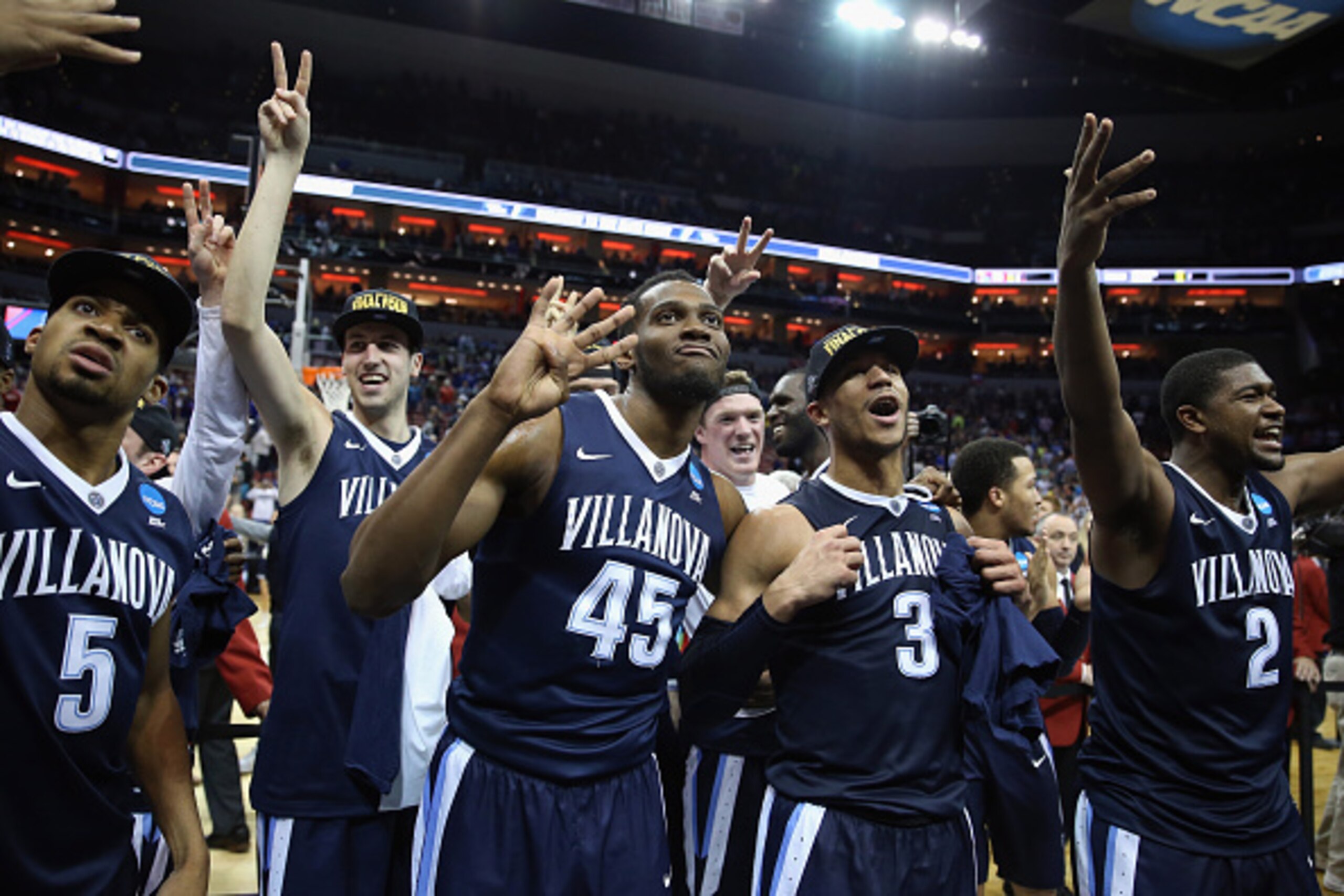 LOUISVILLE, KY - MARCH 26:  (L-R) Phil Booth #5 of the Villanova Wildcats, Kevin Rafferty #52, Darryl Reynolds #45, Josh Hart #3, and Kris Jenkins #2 celebrate defeating the Kansas Jayhawks 64-59 during the 2016 NCAA Men's Basketball Tournament South Regi