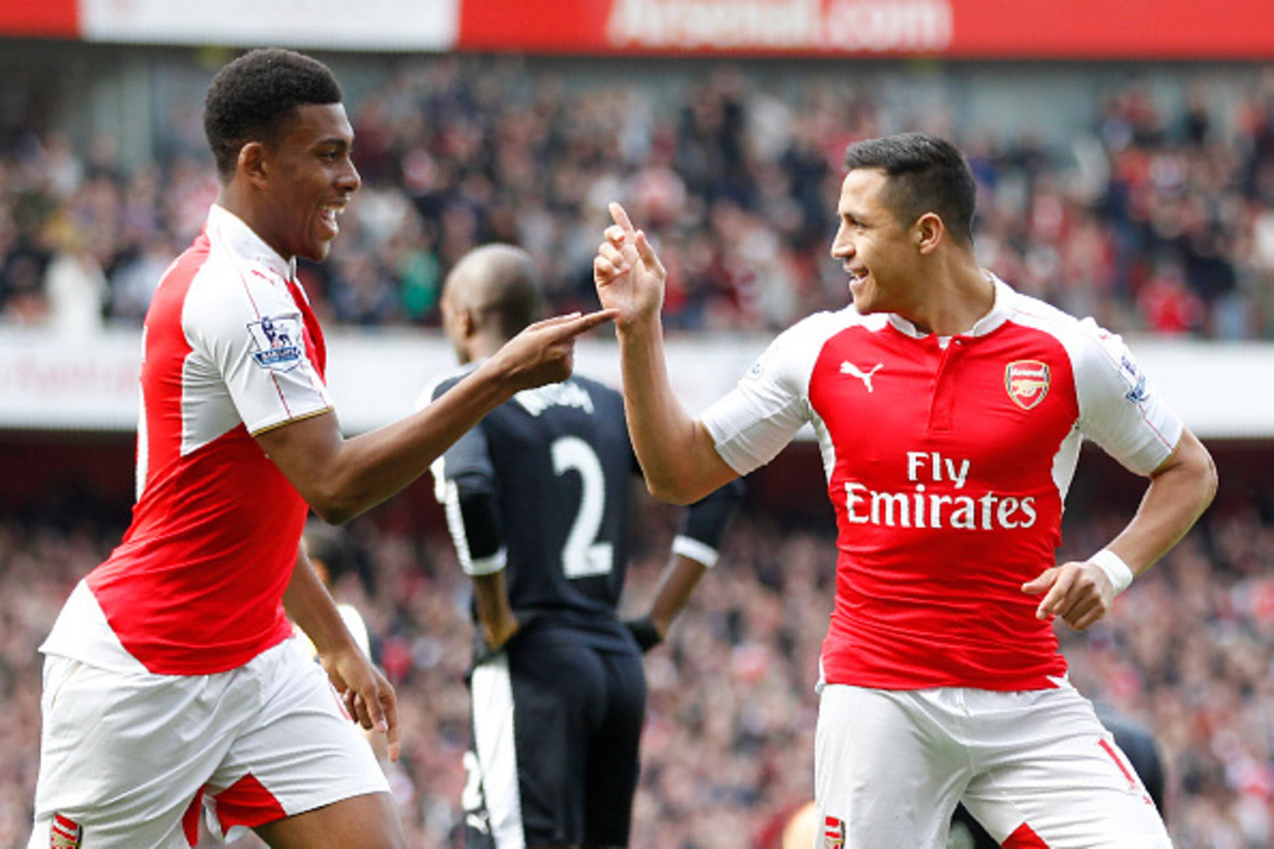 Arsenal's Chilean striker Alexis Sanchez (R) celebrates with Arsenal's Nigerian striker Alex Iwobi after scoring during the English Premier League football match between Arsenal and Watford at the Emirates Stadium in London on April 2, 2016.  / AFP / Ian 