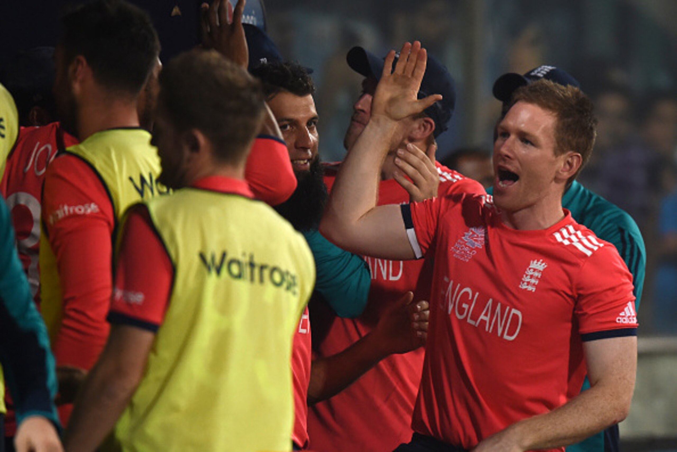 England captain Eoin Morgan (R) celebrates with teammates after winning the World T20 cricket tournament semi-final match between England and New Zealand at the Feroz Shah Kotla cricket ground in New Delhi on March 30, 2016. / AFP / PRAKASH SINGH        (