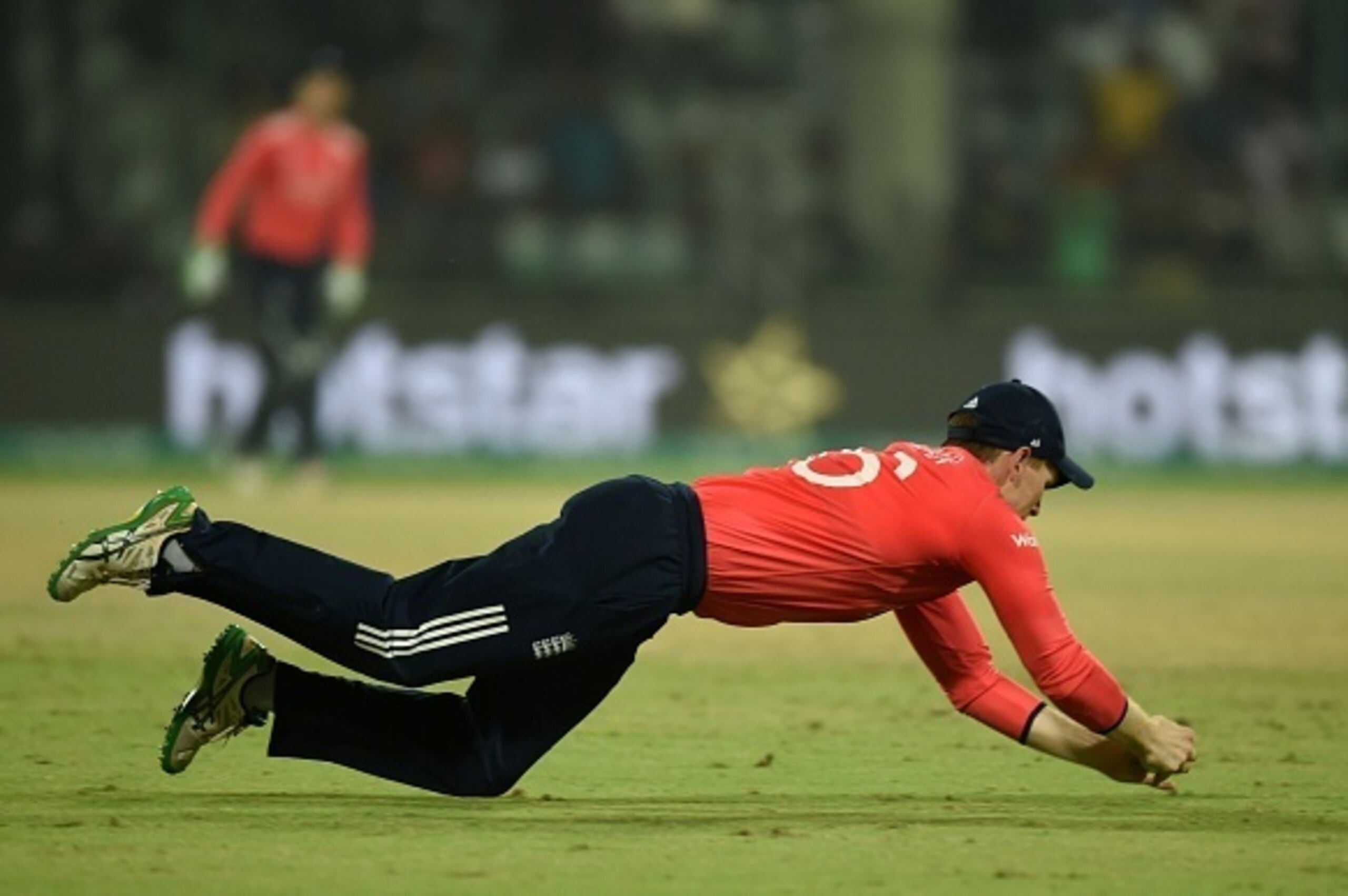 England's captain Eoin Morgan takes a catch to dismiss New Zealand's Ross Taylor during the World T20 cricket tournament first semi-final match between England and New Zealand at Feroz Shah Kotla cricket ground in New Delhi on March 30, 2016. / AFP / PRAK