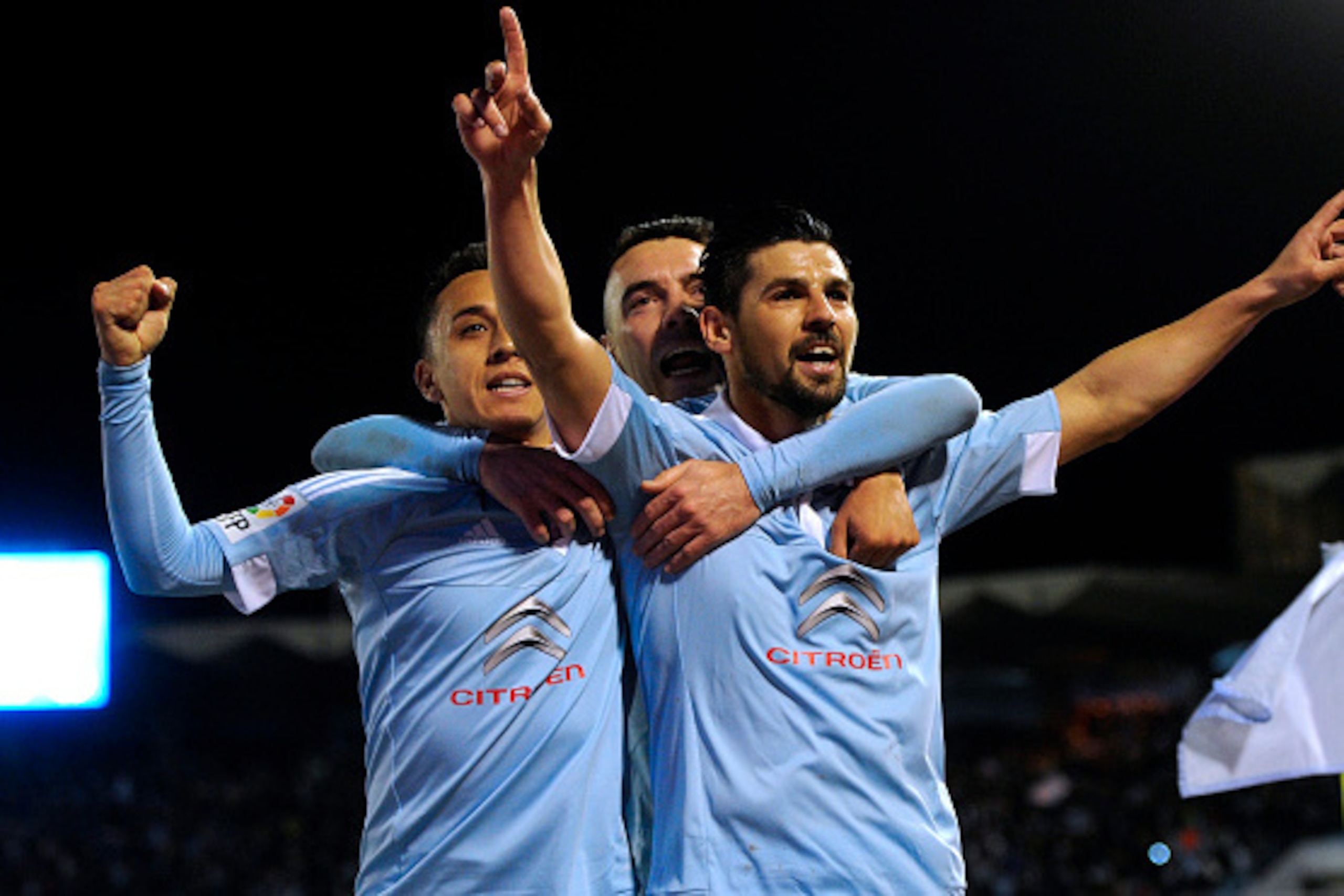 Celta Vigo's forward Nolito (R) celebrates a goal with teammates forward Iago Aspas (C) and Chilean forward Fabian Orellana during the Spanish league football match RC Celta de Vigo vs RC Deportivo at the Balaidos stadium in Vigo on April 2, 2016. / AFP /