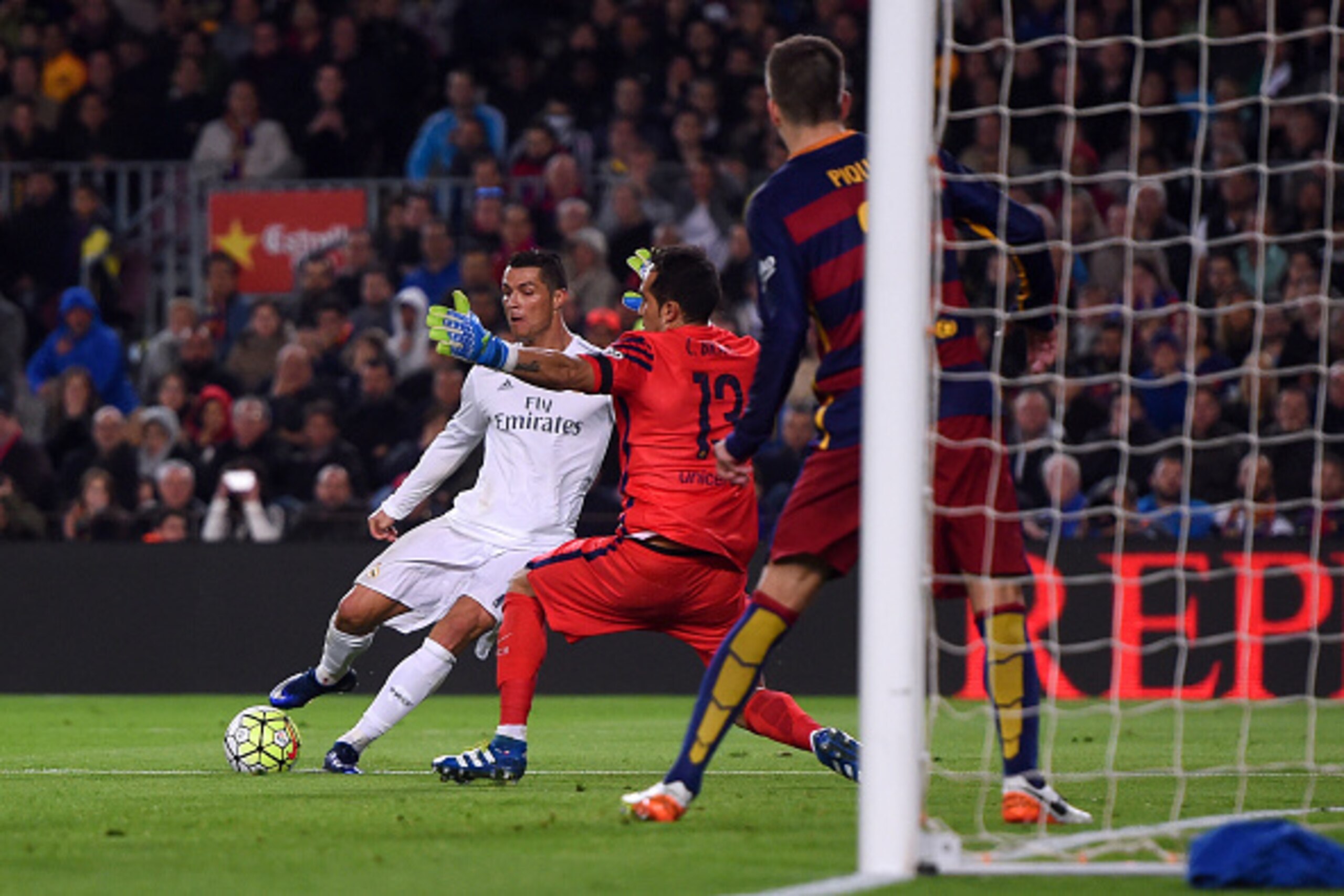 BARCELONA, SPAIN - APRIL 02:  Cristiano Ronaldo of Real Madrid CF slides the ball underneat6h Claudio Bravo of FC Barcelona to score his team's second goal during the La Liga match between FC Barcelona and Real Madrid CF at Camp Nou on April 2, 2016 in Ba