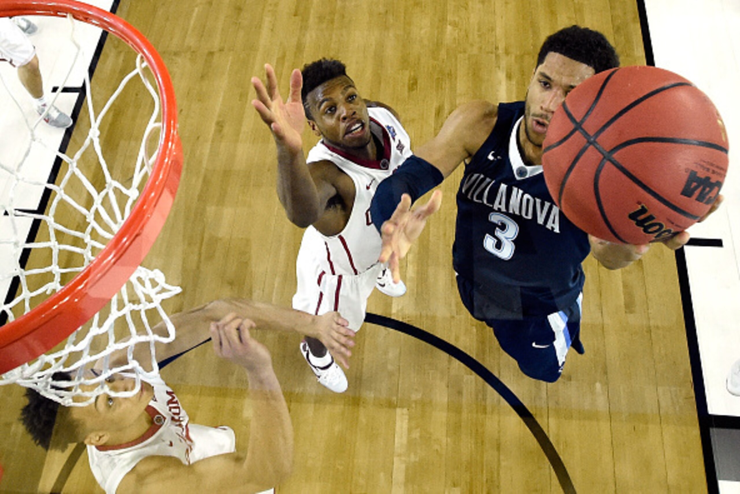 HOUSTON, TEXAS - APRIL 02:  Josh Hart #3 of the Villanova Wildcats drives to the basket against Buddy Hield #24 of the Oklahoma Sooners in the second half during the NCAA Men's Final Four Semifinal at NRG Stadium on April 2, 2016 in Houston, Texas.  (Phot