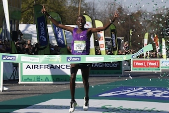 Kenyan Cyprien Kotut passes the finish line as he wins the 40th Paris Marathon, on April 3, 2016 in Paris. Some 57,000 participants from 160 countries have registered with the race covering 42,195km, starting on the Champs Elysees and crossing the French 