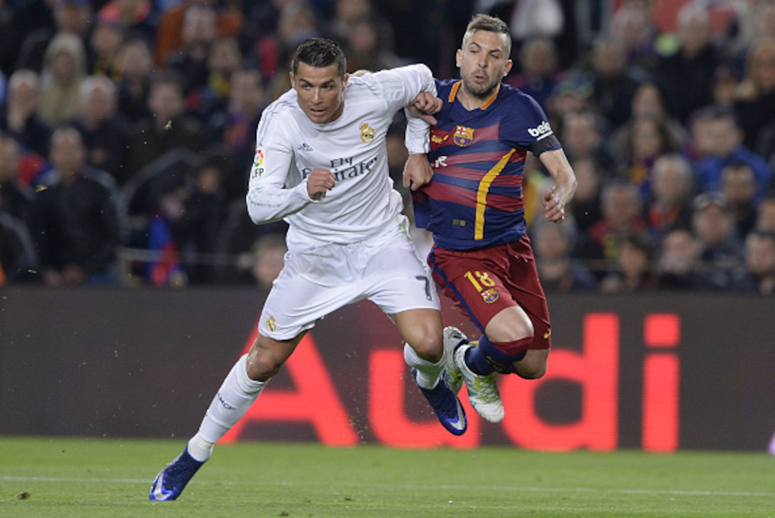 Real Madrid's Portuguese forward Cristiano Ronaldo(L) vies with Barcelona's defender Jordi Alba during the Spanish league 'Clasico' football match FC Barcelona vs Real Madrid CF at the Camp Nou stadium in Barcelona on April 2, 2016. / AFP / JOSEP LAGO    