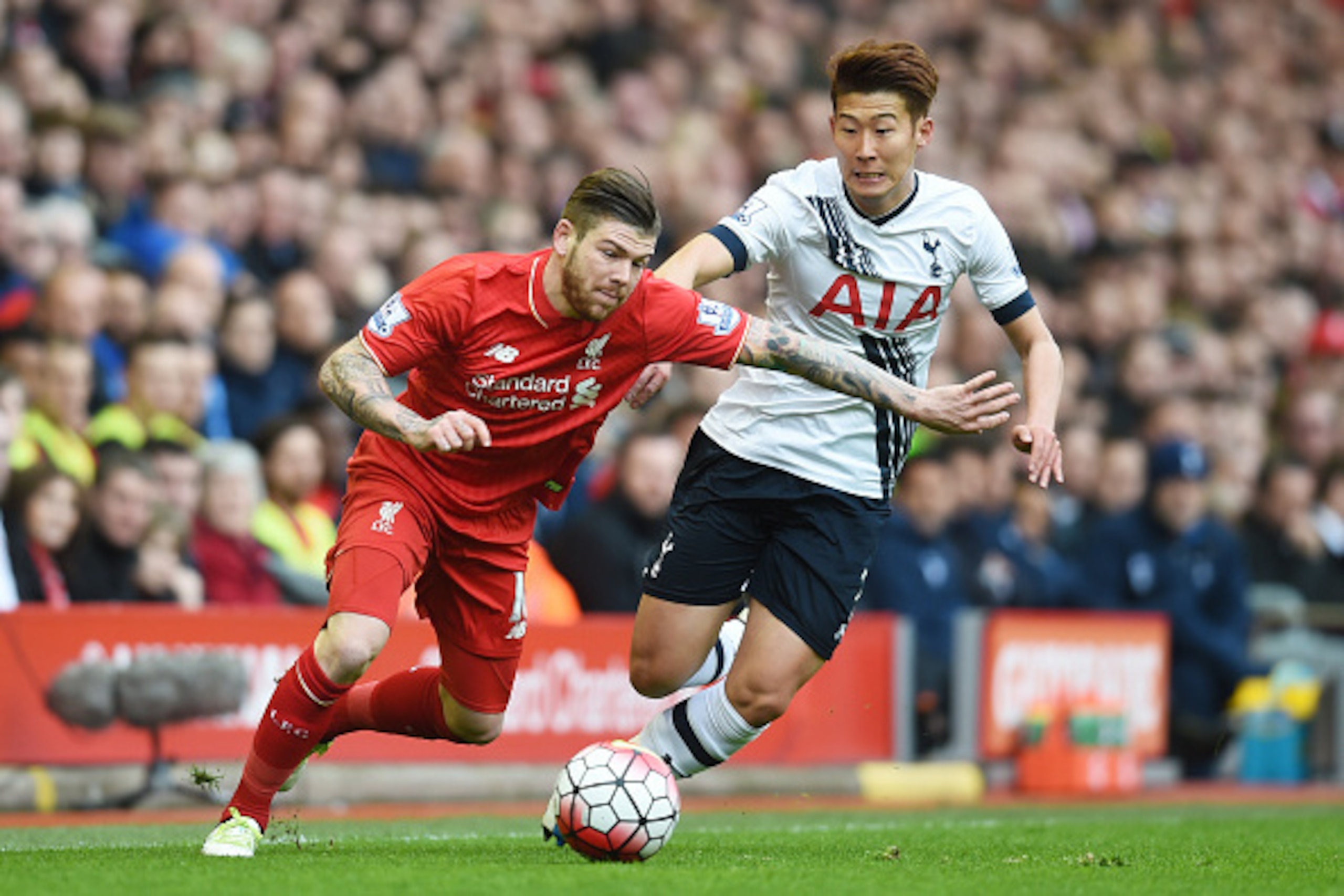 LIVERPOOL, ENGLAND - APRIL 02: Alberto Moreno of Liverpool and Son Heung-min of Tottenham Hotspur compete for the ball during the Barclays Premier League match between Liverpool and Tottenham Hotspur at Anfield on April 2, 2016 in Liverpool, England.  (Ph
