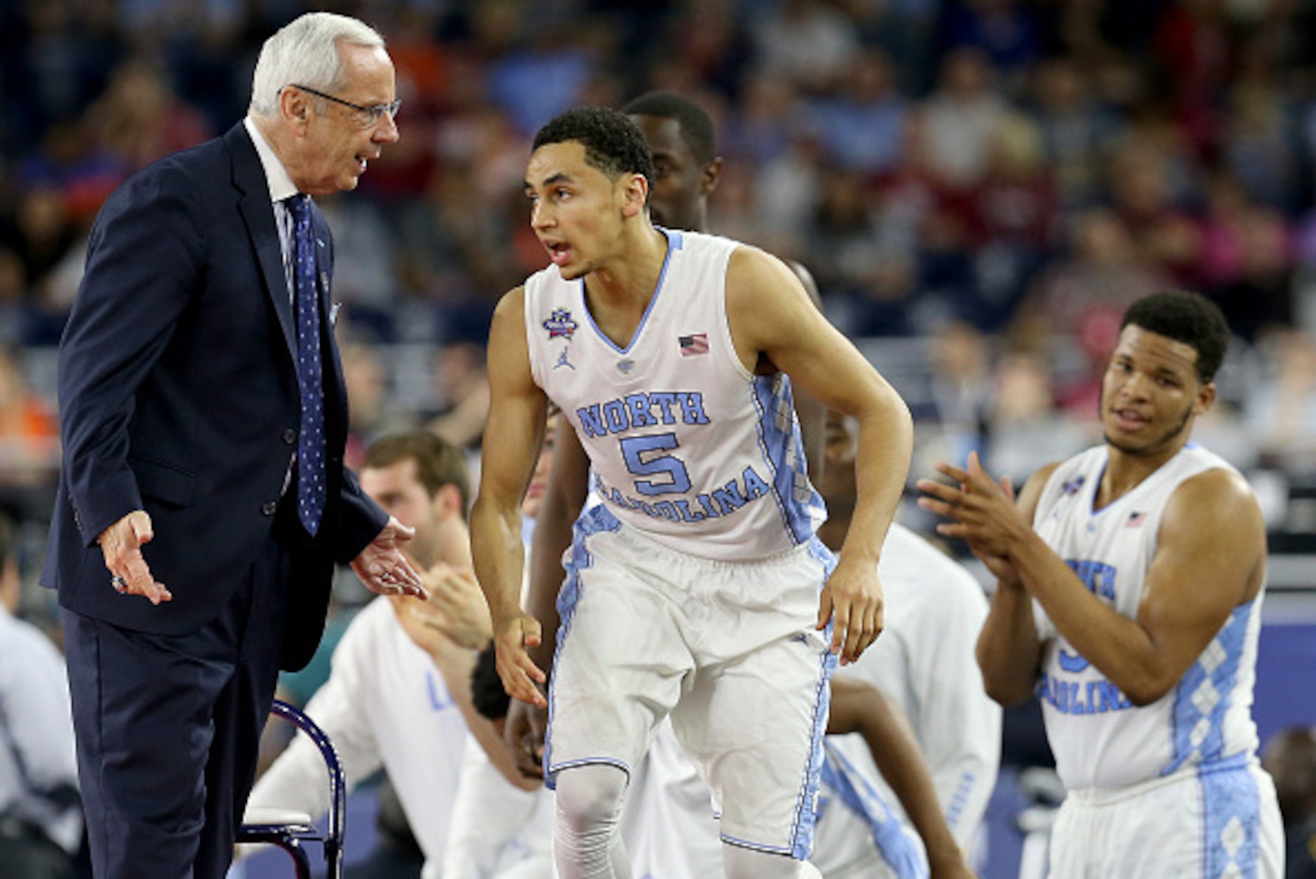 HOUSTON, TEXAS - APRIL 02:  Head coach Roy Williams of the North Carolina Tar Heels talks with Marcus Paige #5 in the second half against the Syracuse Orange during the NCAA Men's Final Four Semifinal at NRG Stadium on April 2, 2016 in Houston, Texas.  (P