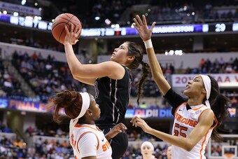 INDIANAPOLIS, IN - APRIL 03:  Kelsey Plum #10 of the Washington Huskies shoots against Julia Chandler #3 and Bria Day #55 of the Syracuse Orange in the first quarter during the semifinals of the 2016 NCAA Women's Final Four Basketball Championship at Bank