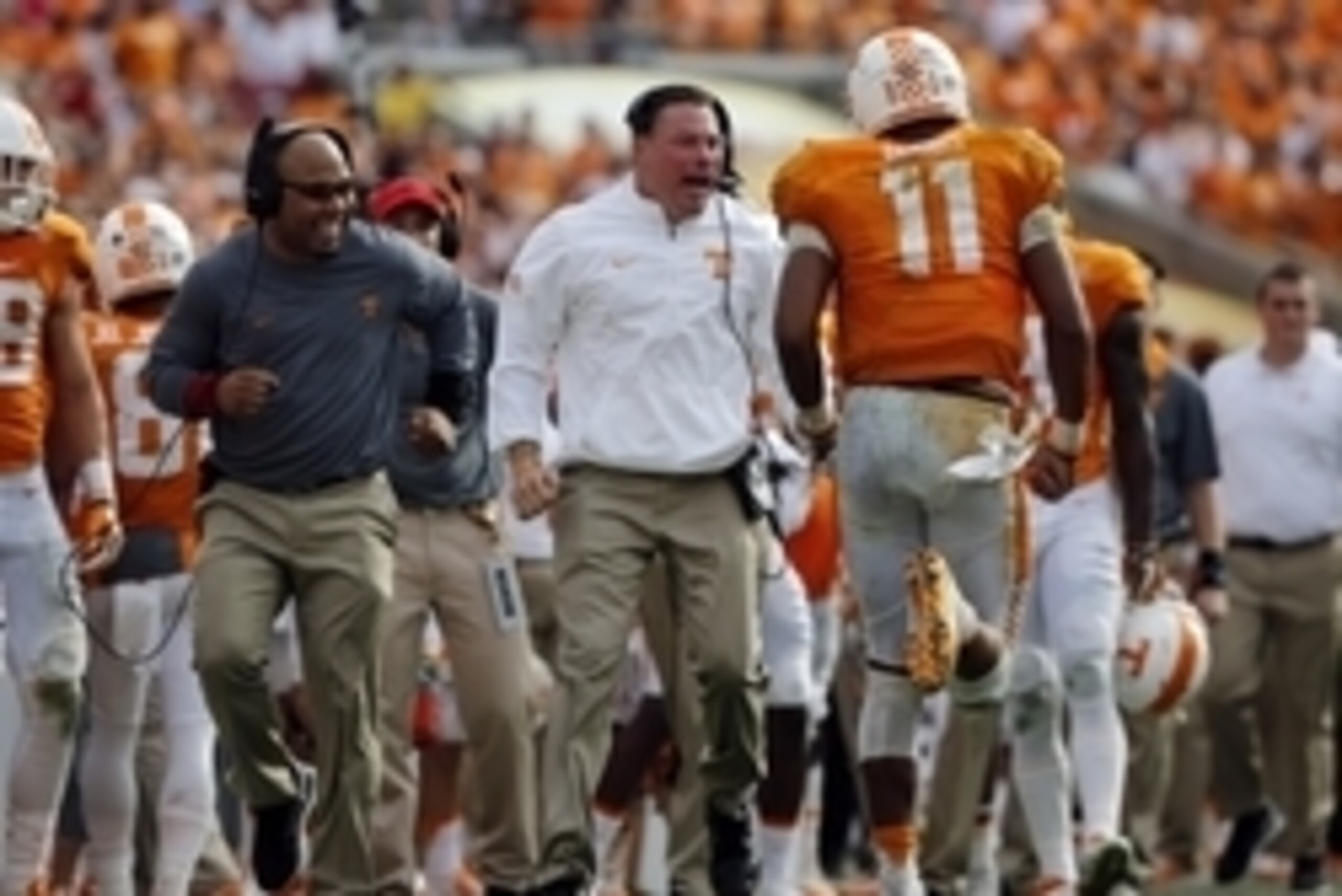 Jan 1, 2016; Tampa, FL, USA; Tennessee Volunteers quarterback Joshua Dobbs (11) is congratulated by head coach Butch Jones and running back coach Robert Gillespie as he scores a touchdown against the Northwestern Wildcats during the second half in the 201