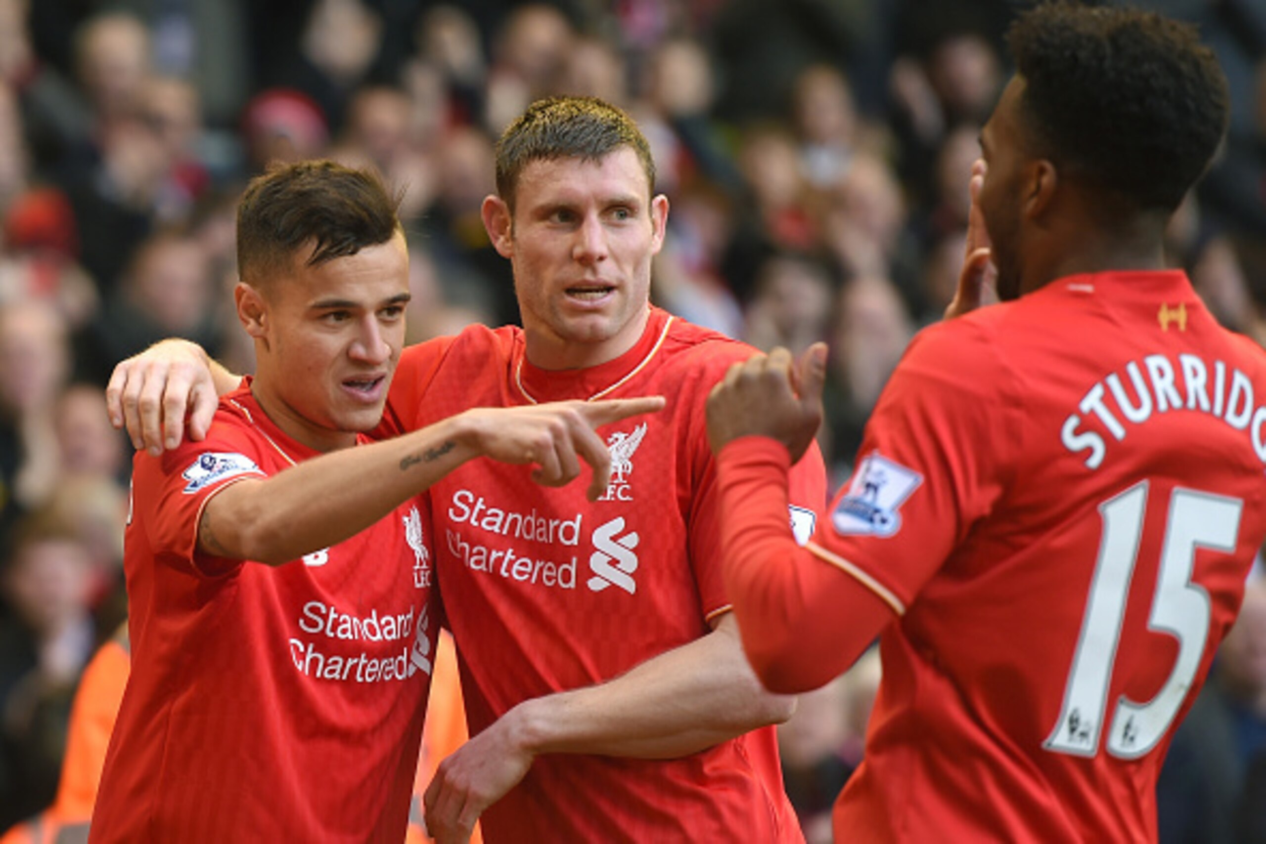 LIVERPOOL, ENGLAND - APRIL 02:  Philippe Coutinho (L) of Liverpool celebrates scoring his team's first goal with his team mates James Milner (C) and Daniel Sturridge (R) during the Barclays Premier League match between Liverpool and Tottenham Hotspur at A
