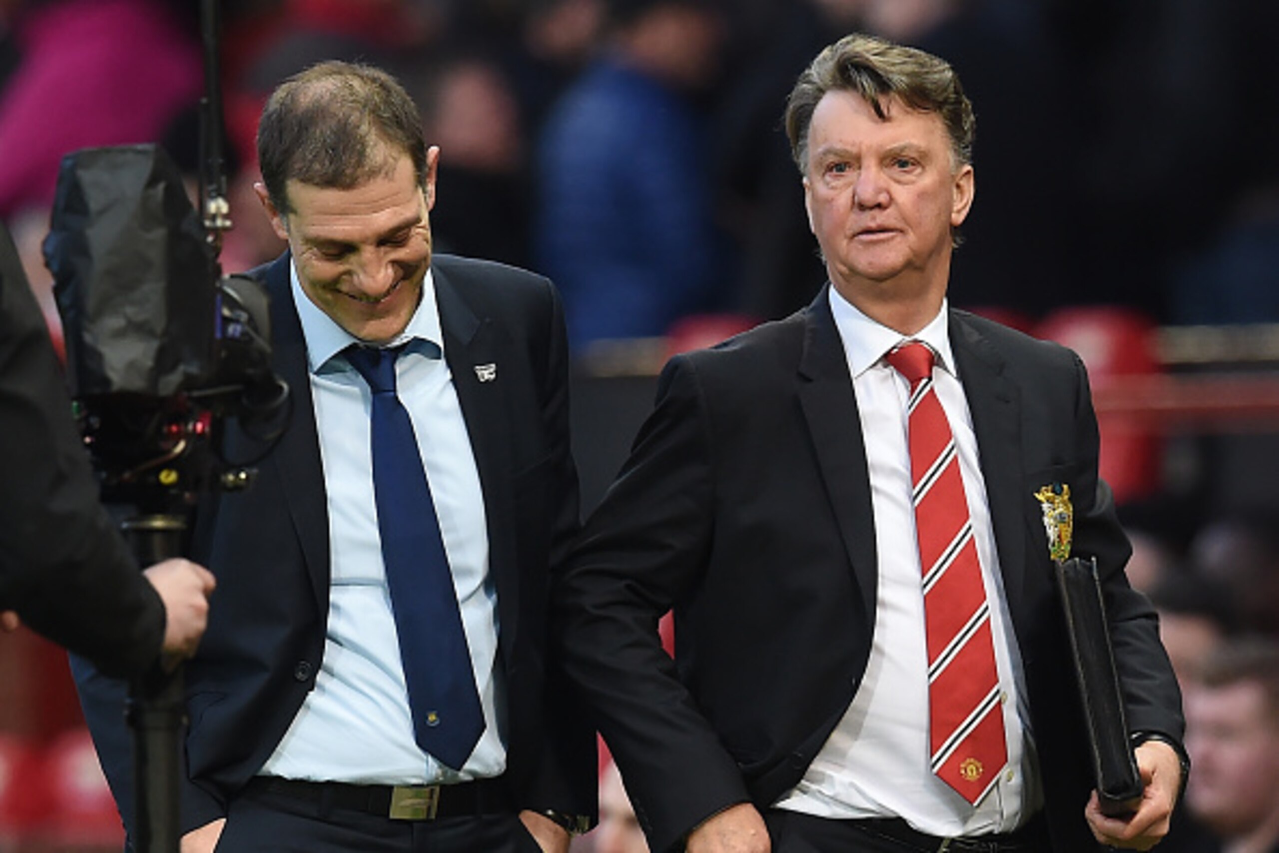West Ham United's Croatian manager Slaven Bilic (L) and Manchester United's Dutch manager Louis van Gaal talk as they leave after the English FA Cup quarter final football match between Manchester United and West Ham United at Old Trafford in Manchester, 