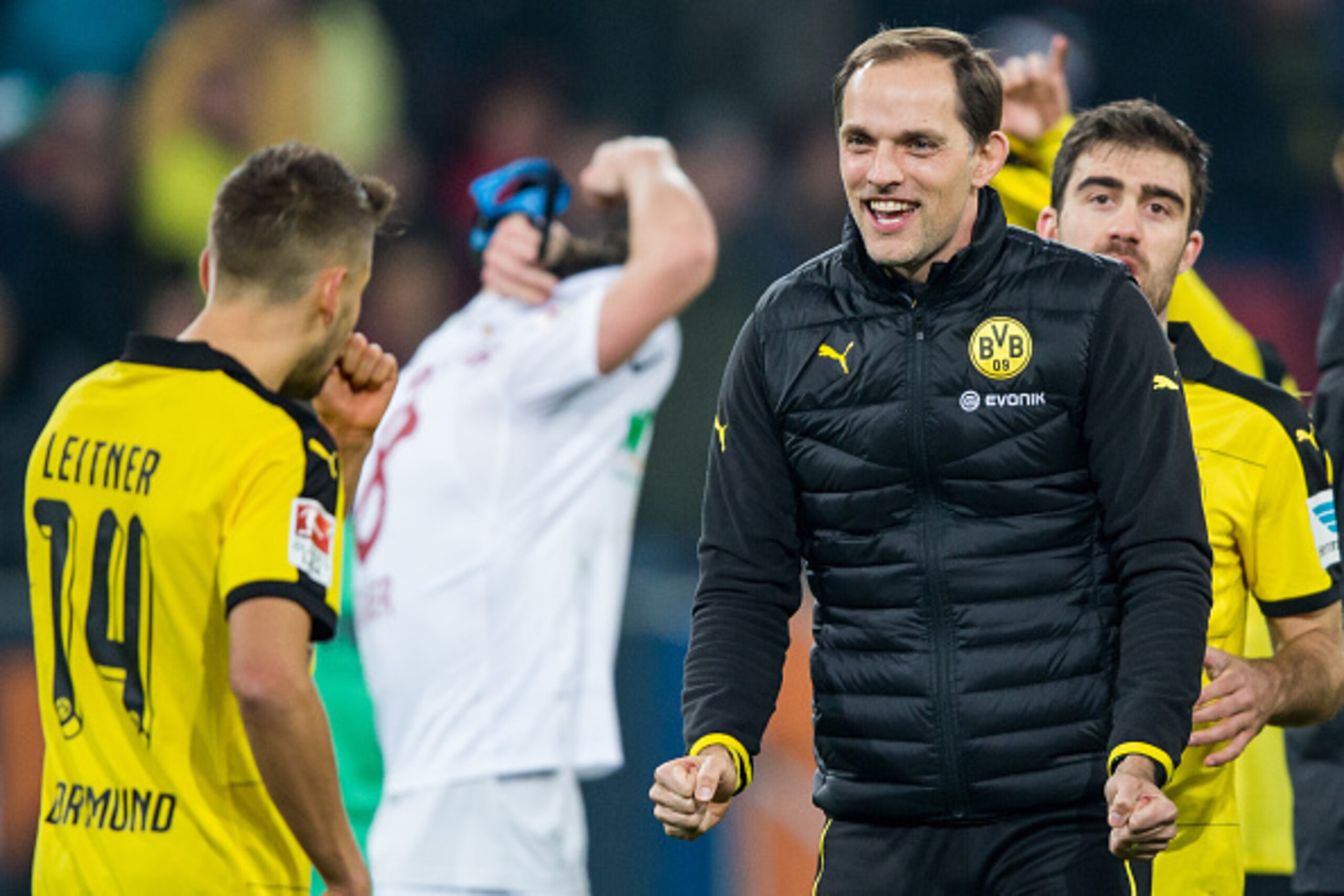 AUGSBURG, GERMANY - MARCH 20:  Head coach Thomas Tuchel of Dortmund celebrates winning with team mate Moritz Leitner (L) after the Bundesliga match between FC Augsburg and Borussia Dortmund at SGL Arena on March 20, 2016 in Augsburg, Germany.  (Photo by S