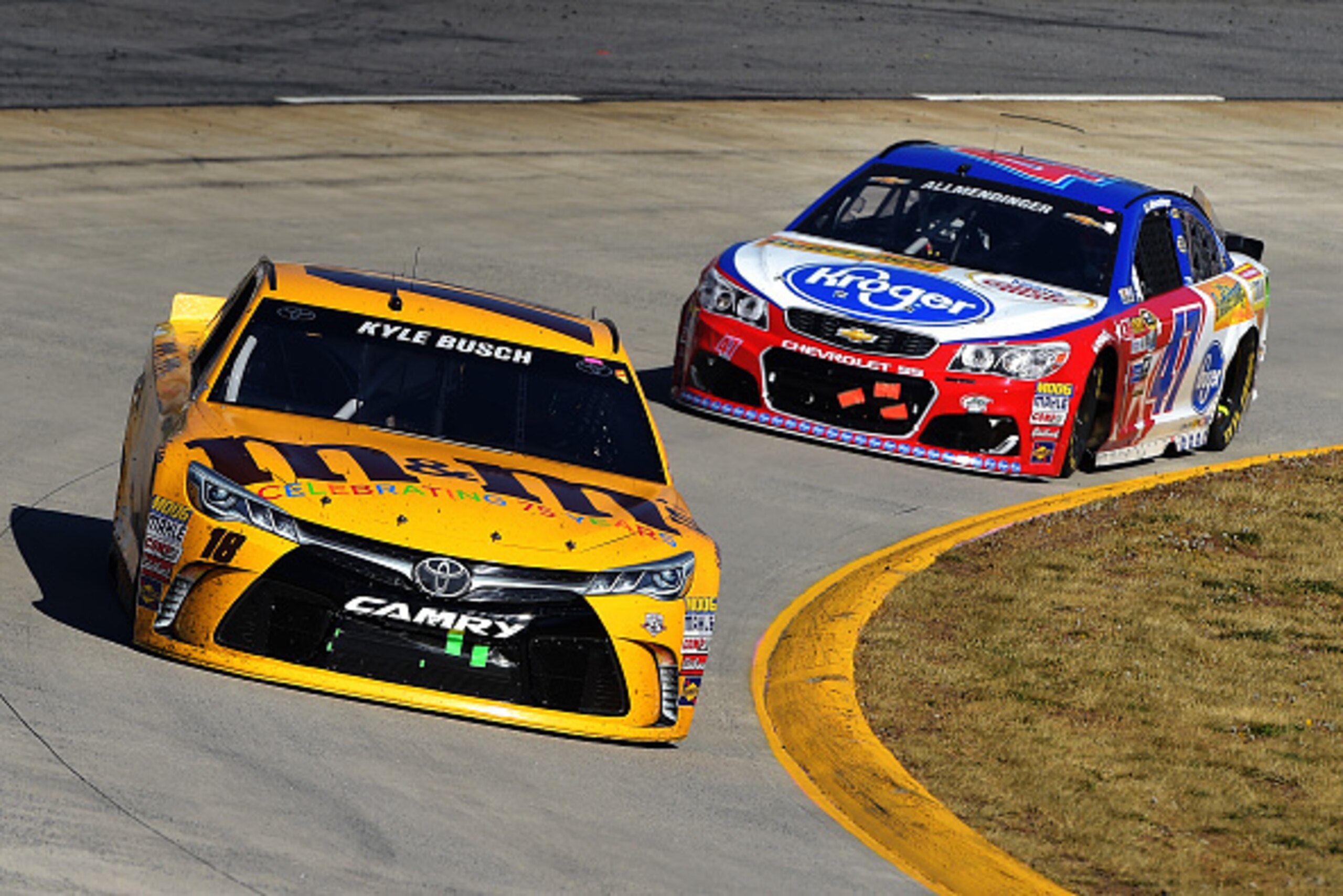 MARTINSVILLE, VA - APRIL 03: Kyle Busch, driver of the #18 M&M's 75th Anniversary Toyota, races AJ Allmendinger, driver of the #47 Kroger/Butterfinger/Coffeemate Chevrolet, during the NASCAR Sprint Cup Series STP 500 at Martinsville Speedway on April 3, MARTINSVILLE, VA - APRIL 03: Kyle Busch, driver of the #18 M&M's 75th Anniversary Toyota, races AJ Allmendinger, driver of the #47 Kroger/Butterfinger/Coffeemate Chevrolet, during the NASCAR Sprint Cup Series STP 500 at Martinsville Speedway on April 3,