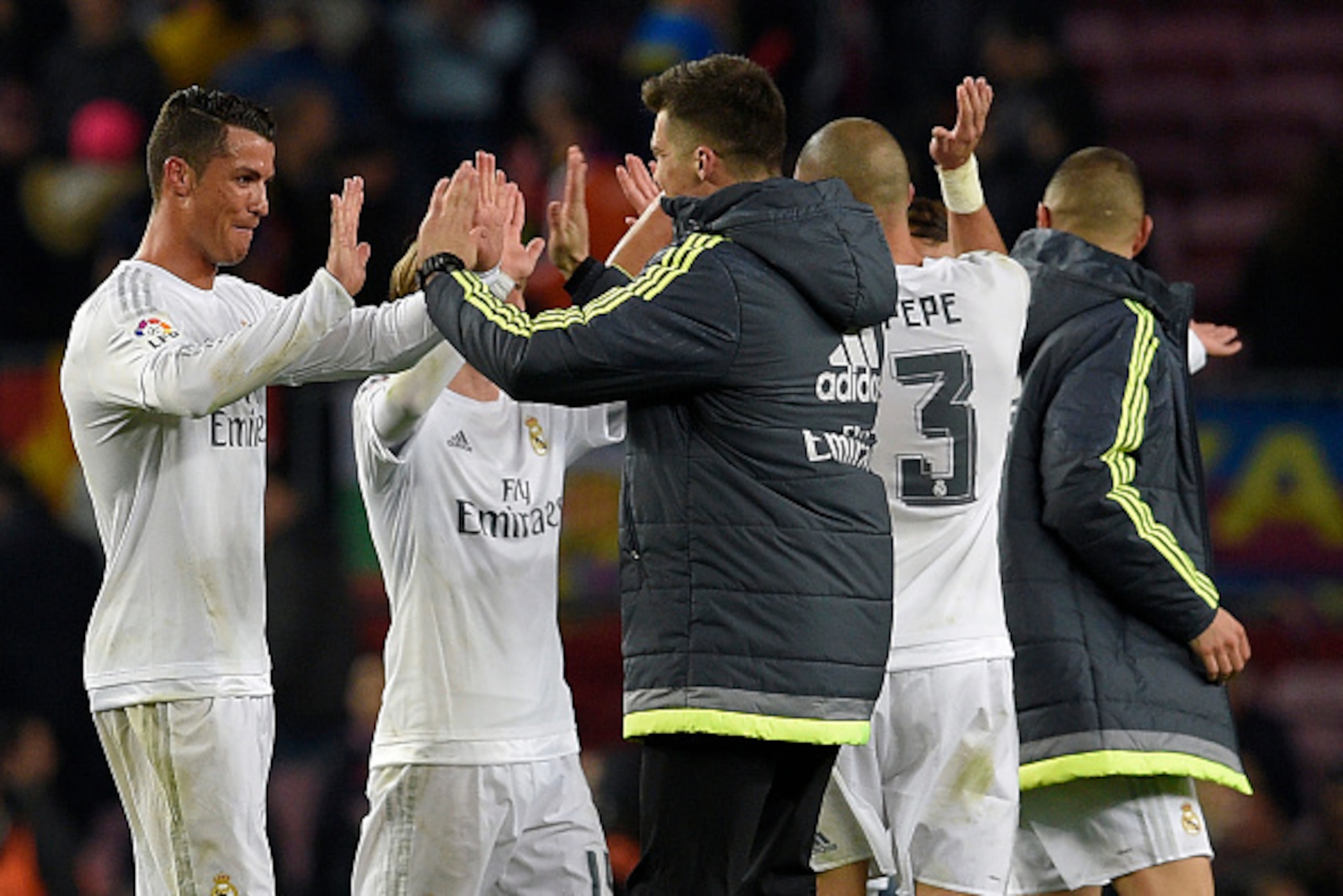 Real Madrid's Portuguese forward Cristiano Ronaldo (L) celebrates after the Spanish league 'Clasico' football match FC Barcelona vs Real Madrid CF at the Camp Nou stadium in Barcelona on April 2, 2016. / AFP / LLUIS GENE        (Photo credit should read L