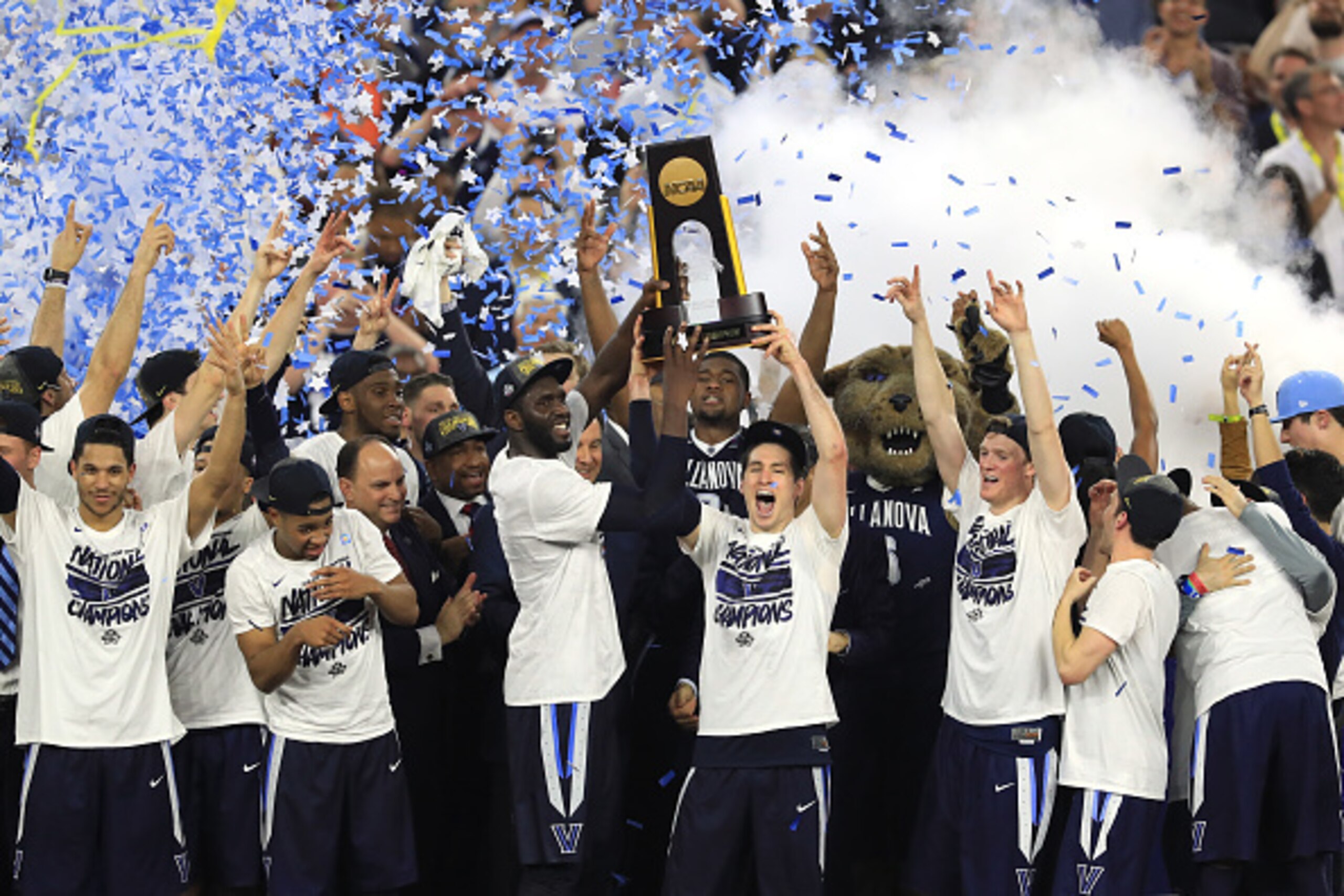 HOUSTON, TEXAS - APRIL 04:  Daniel Ochefu #23 of the Villanova Wildcats and Ryan Arcidiacono #15 hoist the trophy after the Villanova Wildcats defeat the North Carolina Tar Heels 77-74 to win the 2016 NCAA Men's Final Four National Championship game at NR