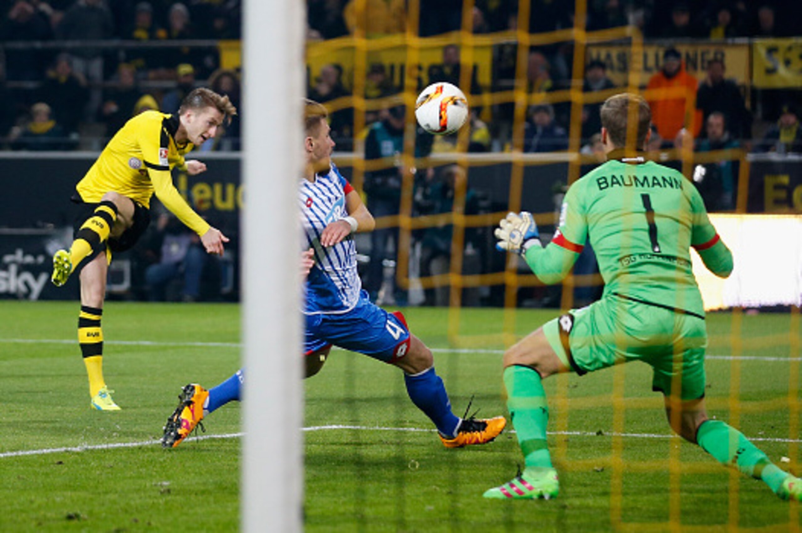DORTMUND, GERMANY - FEBRUARY 28:  Marco Reus (L) of Borussia Dortmund tries to score against goalkeeper Oliver Baumann of 1899 Hoffenheim during the Bundesliga match between Borussia Dortmund and 1899 Hoffenheim at Signal Iduna Park on February 28, 2016 i