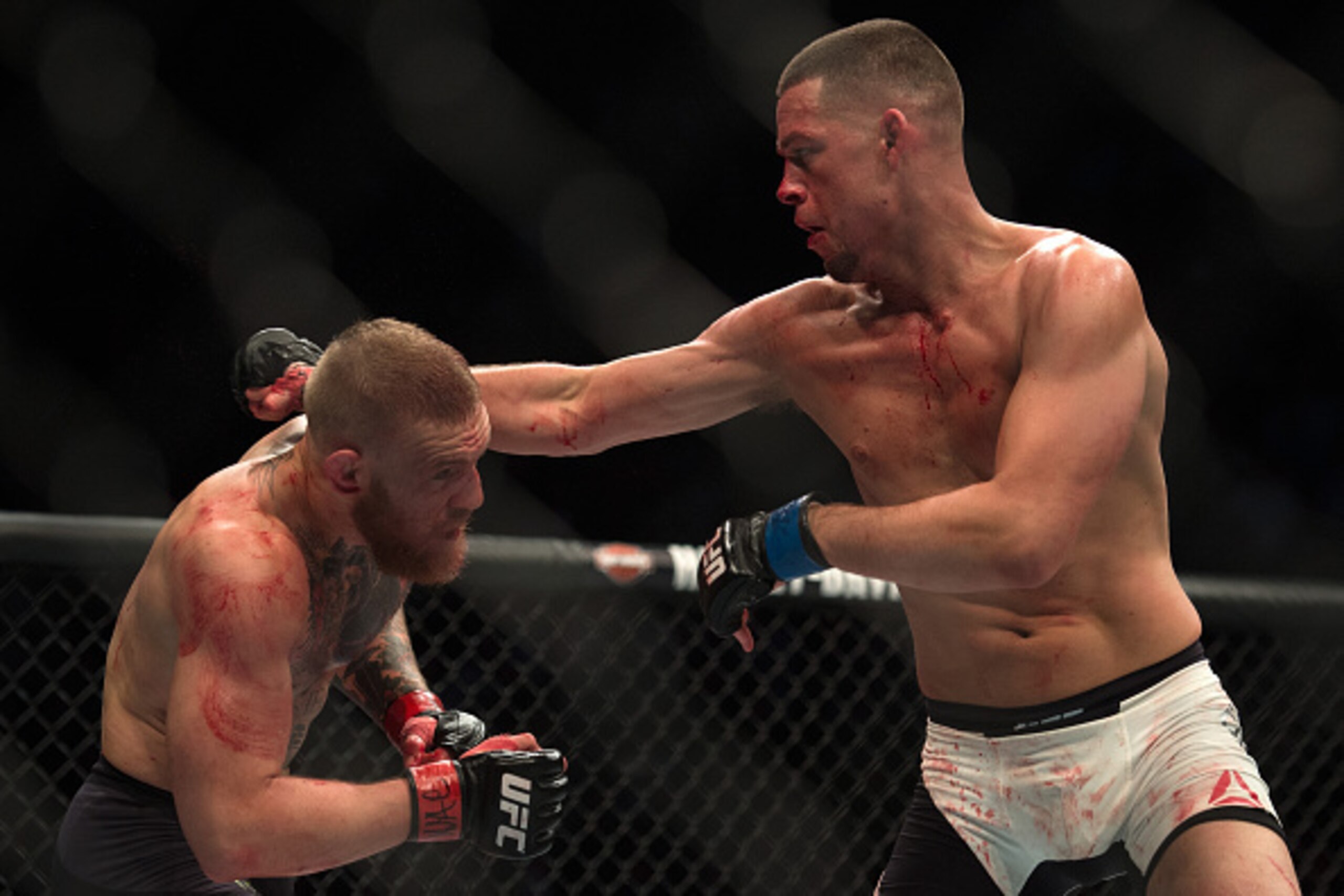 LAS VEGAS, NV - MARCH 5:   (R-L) Nate Diaz punches Conor McGregor in their welterweight bout during the UFC 196 in the MGM Grand Garden Arena on March 5, 2016 in Las Vegas, Nevada. (Photo by Brandon Magnus/Zuffa LLC/Zuffa LLC via Getty Images)
