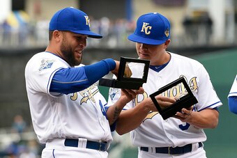 KANSAS CITY, MO - APRIL 5:  Kelvin Herrera #40  and Kris Medlen #39 of the Kansas City Royals look at their World Series Championship ring during a ceremony prior to a game against the New York Mets at Kauffman Stadium on April 5, 2016 in Kansas City, Mis