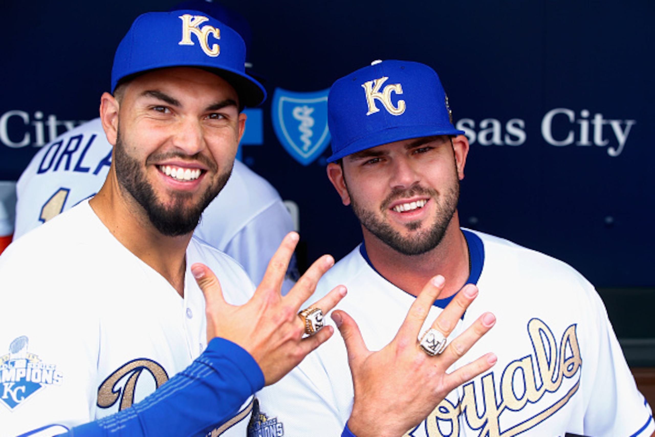 KANSAS CITY, MISSOURI - APRIL 05:  Eric Hosmer #35 and Mike Moustakas #8 of the Kansas City Royals pose with their World Series Championship rings after a ring ceremony prior to the game between the Royals and the New York Mets at Kauffman Stadium on Apri