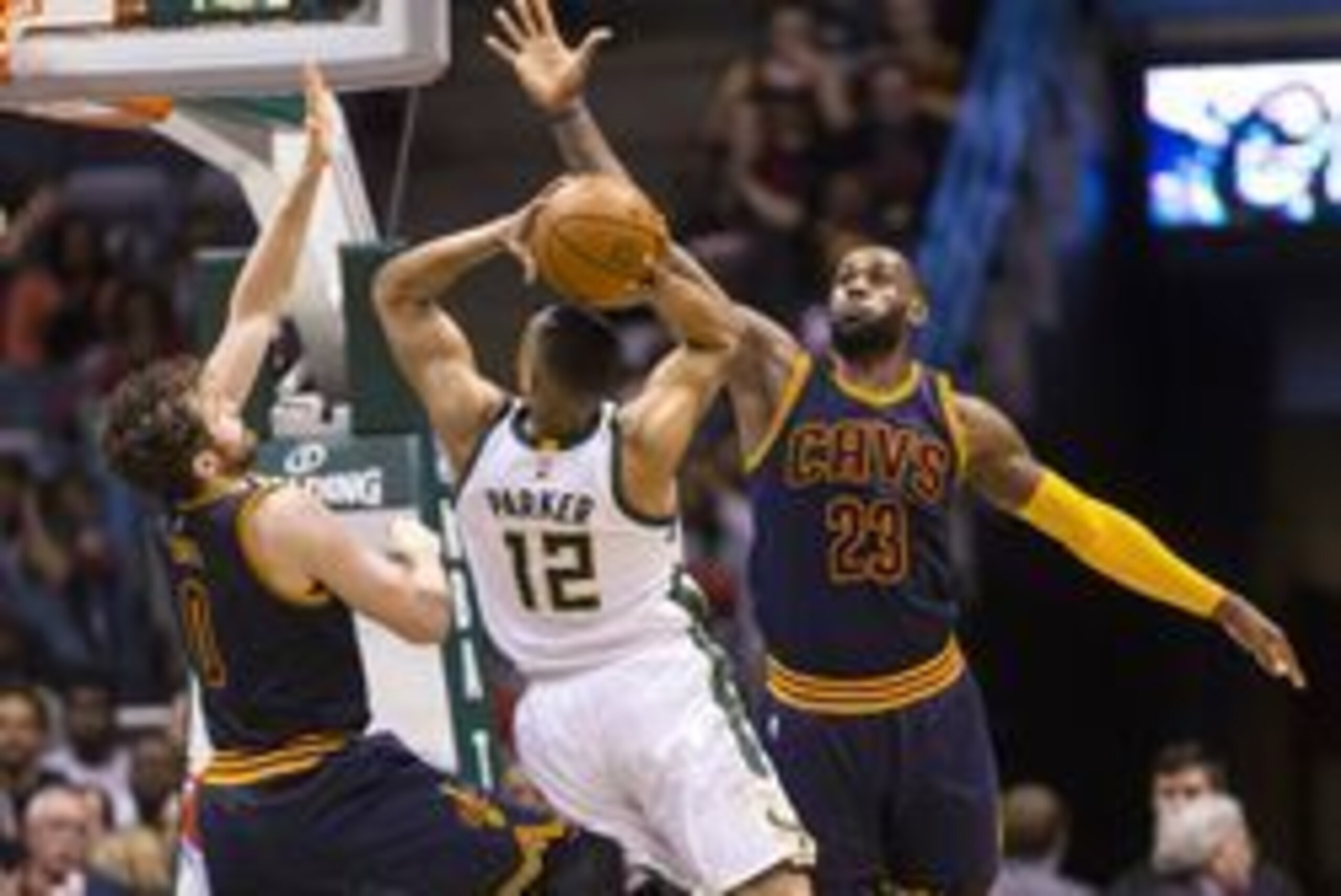 Apr 5, 2016; Milwaukee, WI, USA; Milwaukee Bucks forward Jabari Parker (12) shoots between Cleveland Cavaliers forward Kevin Love (0) and forward LeBron James (23) during the second quarter at BMO Harris Bradley Center. Mandatory Credit: Jeff Hanisch-USA 