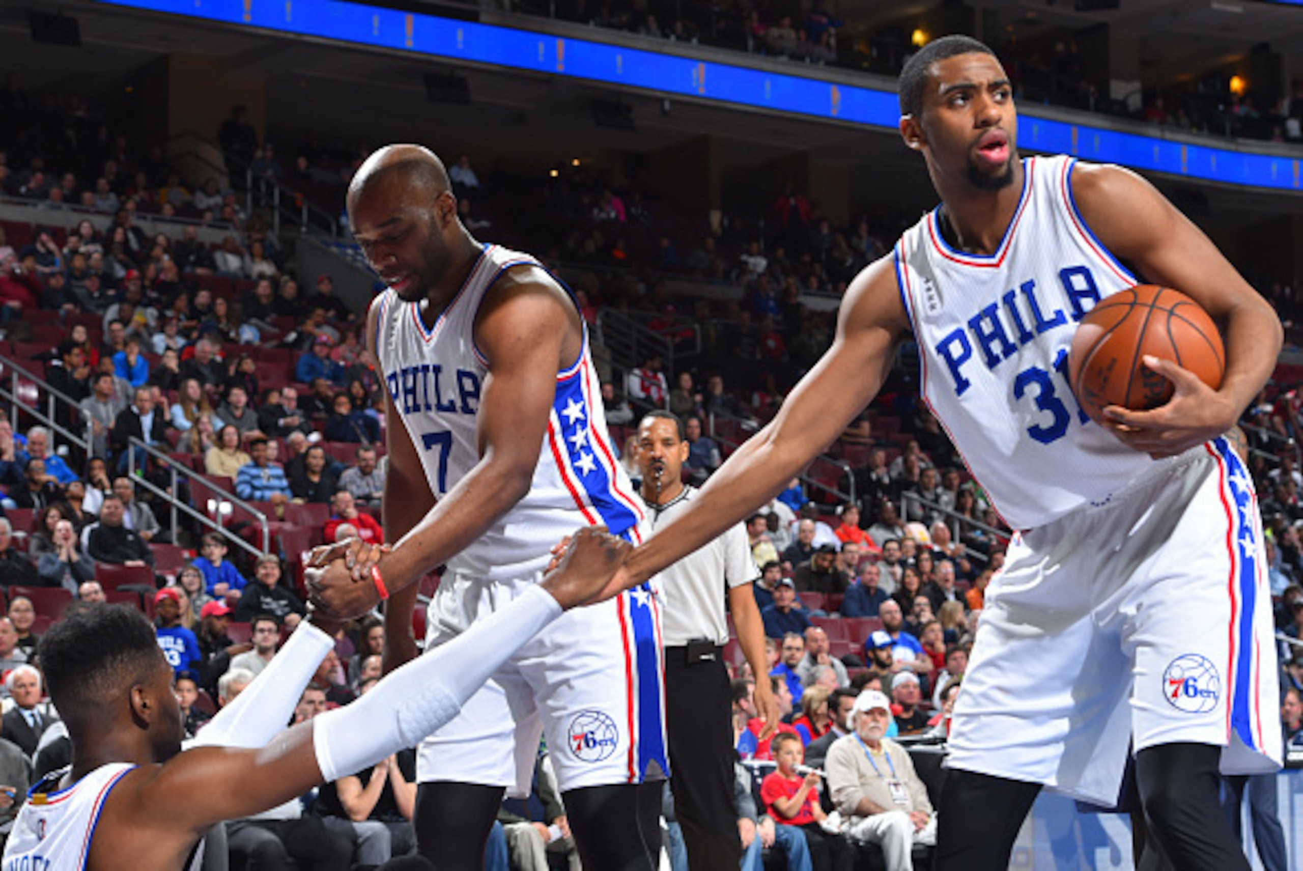 PHILADELPHIA,PA - APRIL 5: Hollis Thompson #31 and Carl Landry # 7 of the Philadelphia 76ers help up teammate Nerlens Noel #4 against New Orleans Pelicans the at Wells Fargo Center on April 5, 2016 in Philadelphia, Pennsylvania NOTE TO USER: User expressl