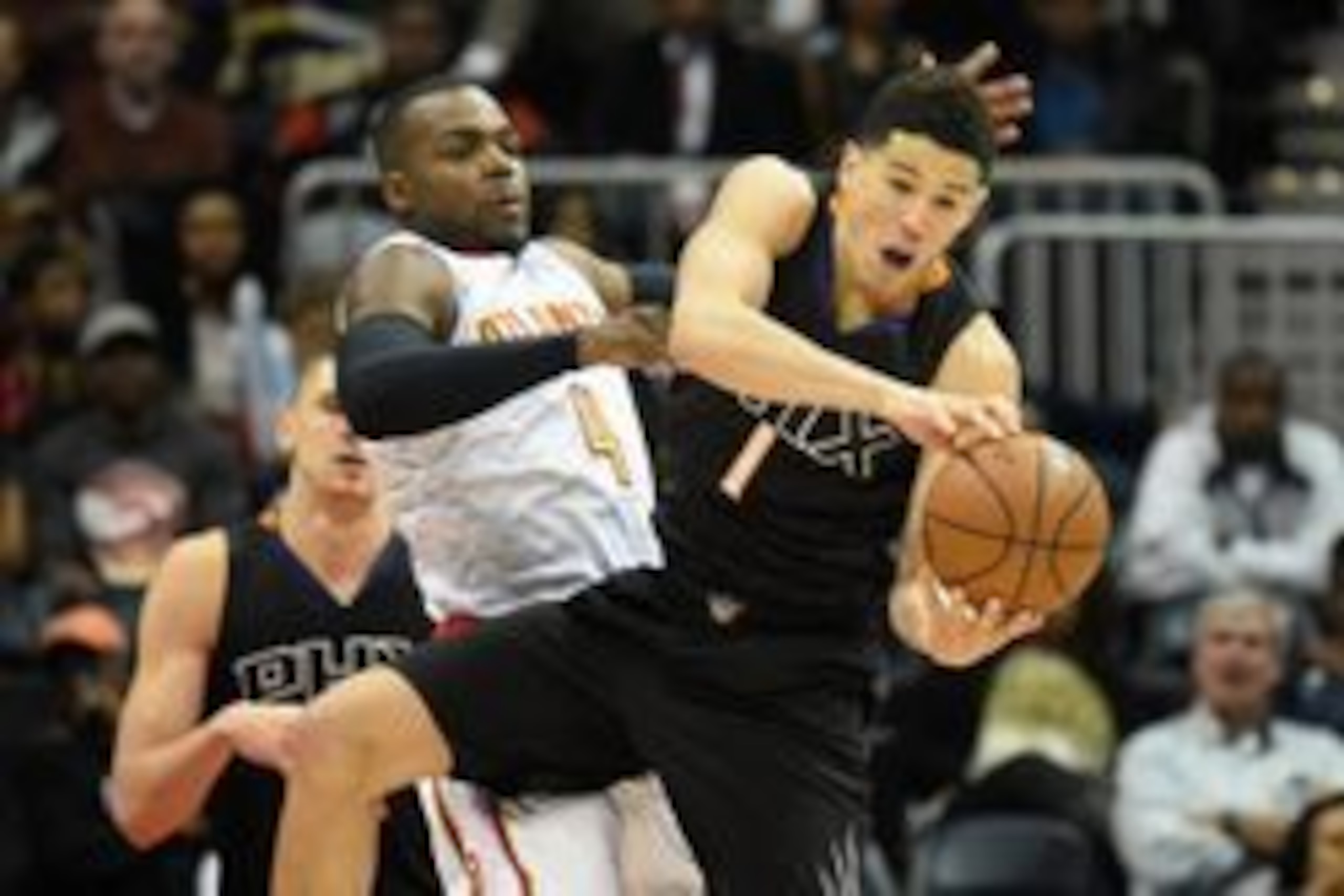 Apr 5, 2016; Atlanta, GA, USA; Phoenix Suns guard Devin Booker (1) and Atlanta Hawks forward Paul Millsap (4) collide as they go for the ball during the second half at Philips Arena. The Hawks defeated the Suns 103-90. Mandatory Credit: Dale Zanine-USA TO