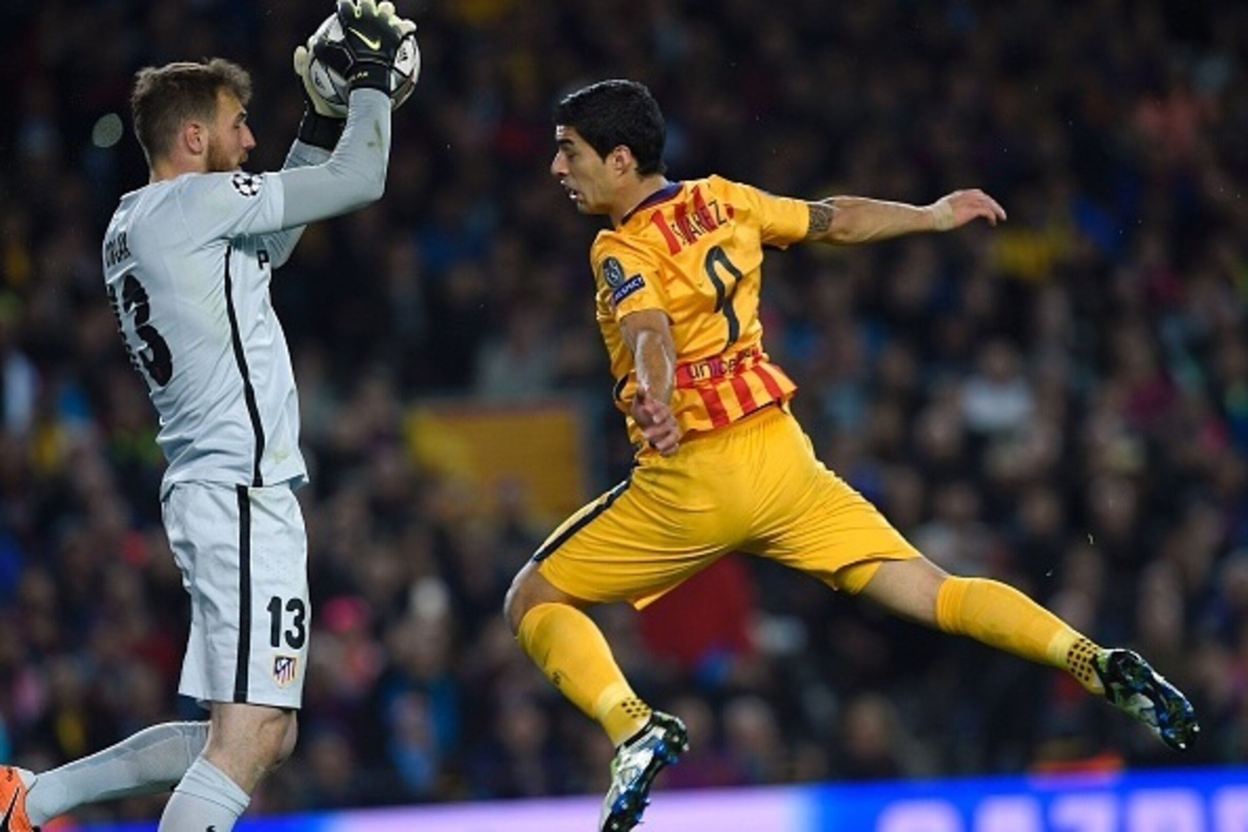 Barcelona's Uruguayan forward Luis Suarez (R) jumps pas Atletico Madrid's Slovenian goalkeeper Jan Oblak during the UEFA Champions League quarter finals first leg football match FC Barcelona vs Atletico de Madrid at the Camp Nou stadium in Barcelona on Ap
