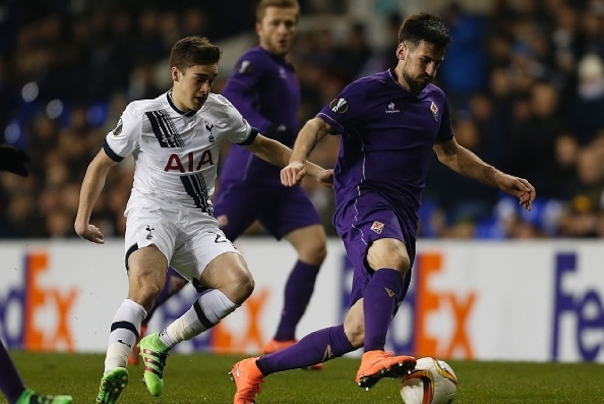 Tottenham Hotspur's English midfielder Harry Winks (L) vies with Fiorentina's Serbian defender Nenad Tomovic during the UEFA Europa League round of 32, second leg football match between Tottenham Hotspur and Fiorentina at White Hart Lane in London, on Feb
