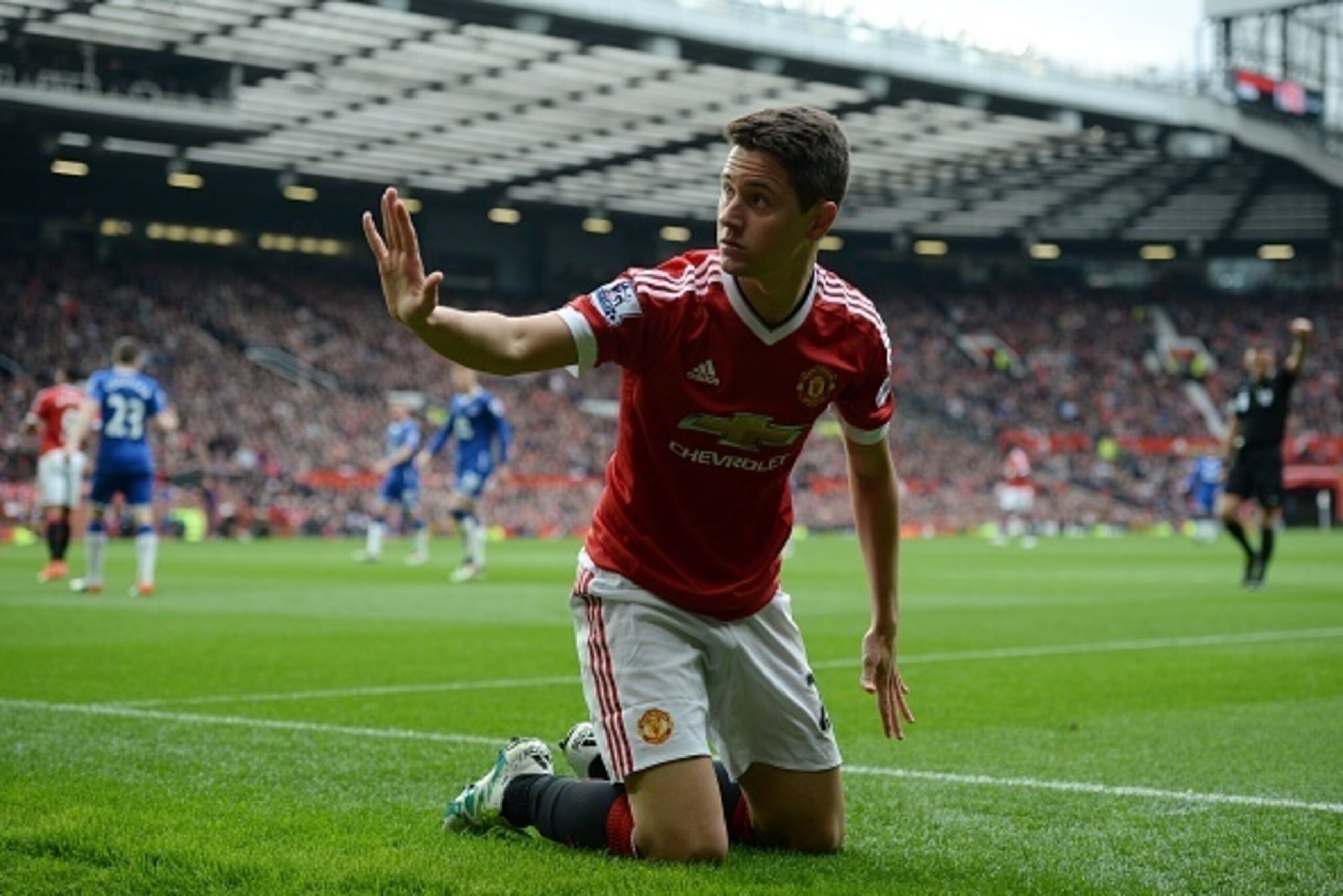 Manchester United's Spanish midfielder Ander Herrera raises a hand to a member of the crowd after his attempted cross went into the crowd and hit a fan during the English Premier League football match between Manchester United and Everton at Old Trafford 