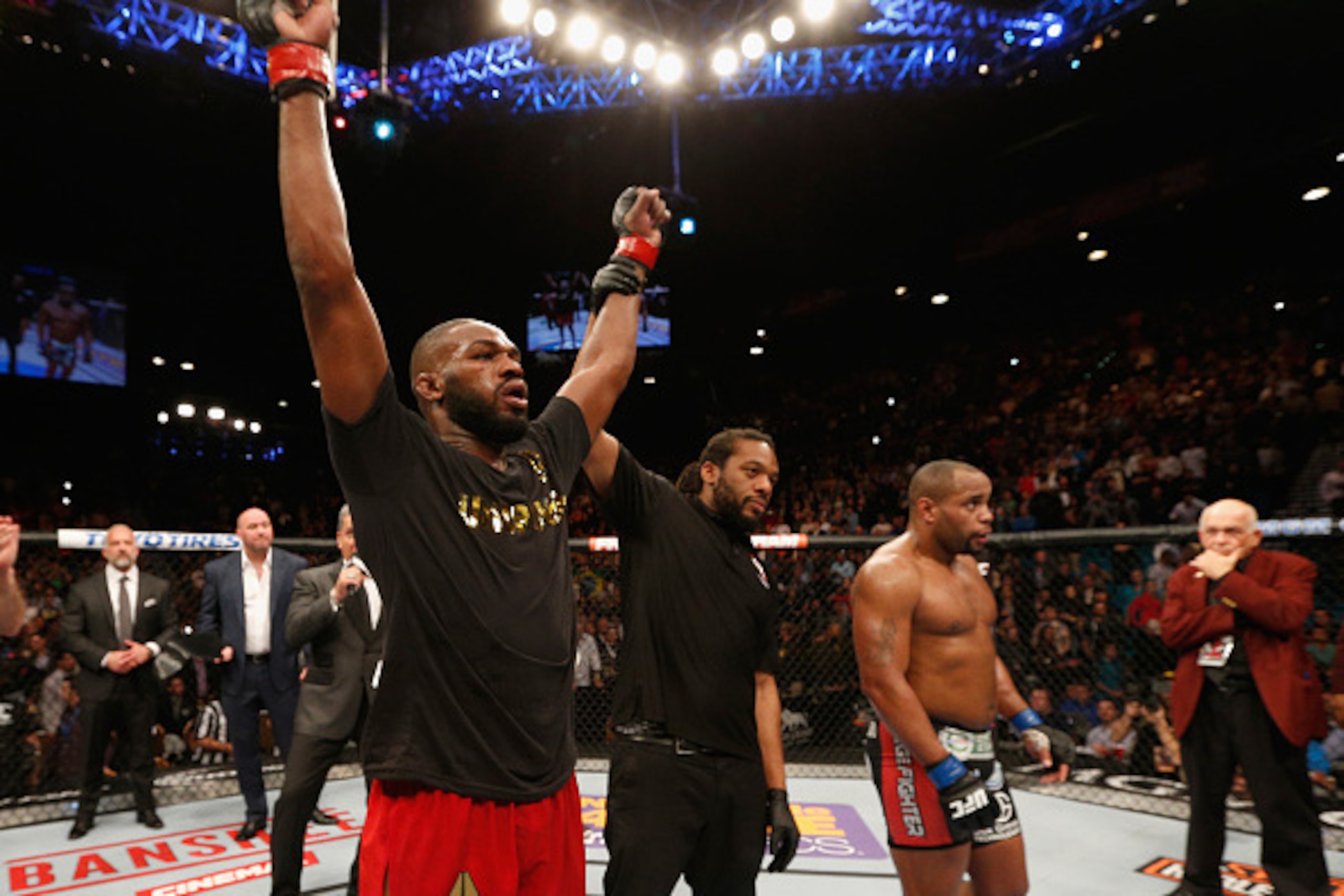 LAS VEGAS, NV - JANUARY 03:  UFC light heavyweight champion Jon Jones (L) celebrates his win over Daniel Cormier (R) in their UFC light heavyweight championship bout during the UFC 182 event at the MGM Grand Garden Arena on January 3, 2015 in Las Vegas, N