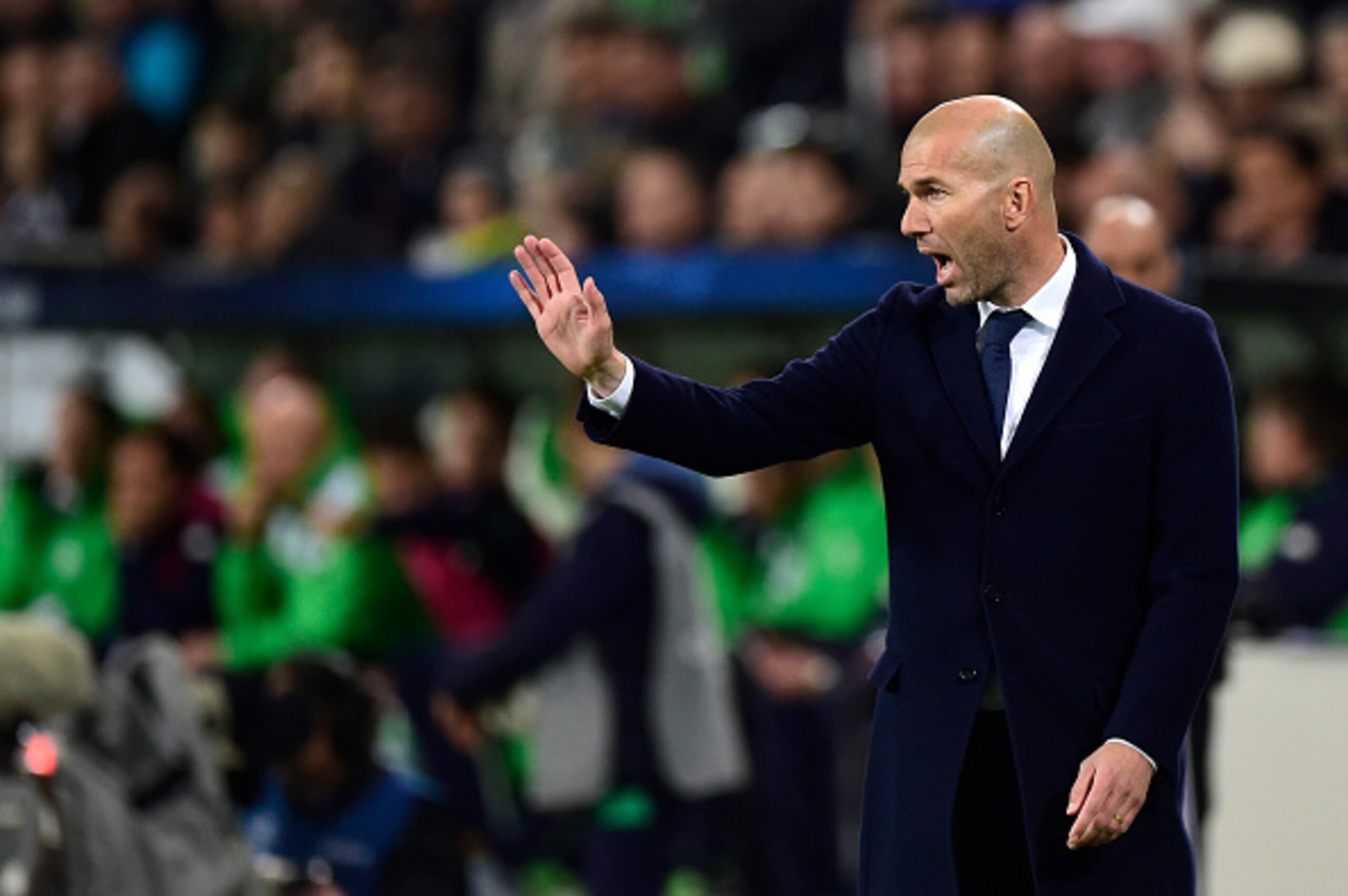 Real Madrid's French coach Zinedine Zidane reacts during the UEFA Champions League quarter-final, first-leg football match between VfL Wolfsburg and Real Madrid on April 6, 2016 in Wolfsburg, northern Germany.  / AFP / John MACDOUGALL        (Photo credit