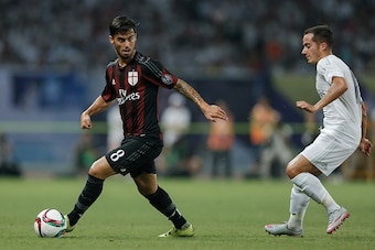 SHANGHAI, CHINA - JULY 30:  Lucas Vazquez (R) of Real Madrid contests the ball against Suso of AC Milan during the International Champions Cup match between Real Madrid and AC Milan at Shanghai Stadium on July 30, 2015 in Shanghai, China.  (Photo by Linta
