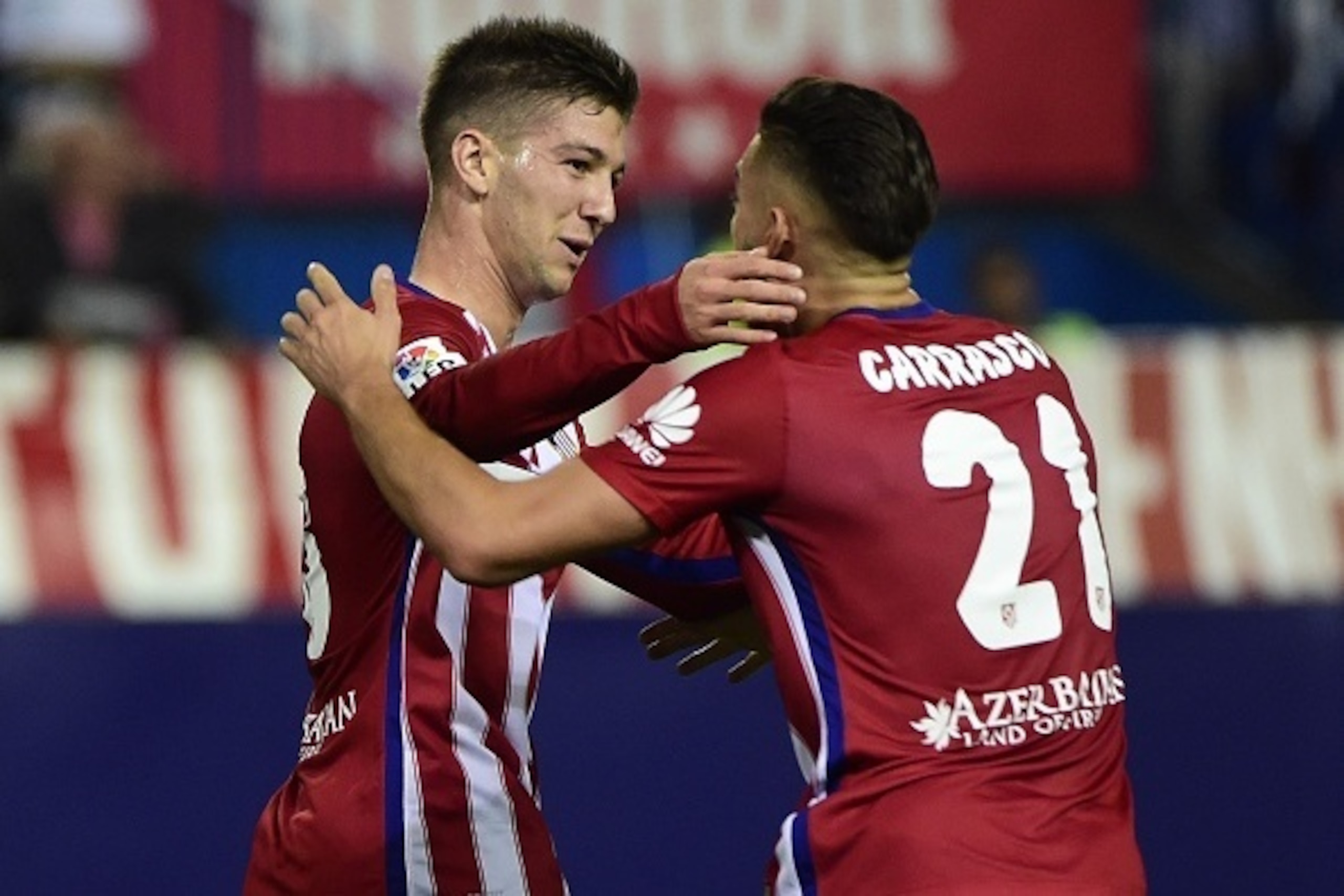 Atletico Madrid's Argentinian forward Luciano Vietto (L) celebrates with Atletico Madrid's Belgian midfielder Yannick Ferreira Carrasco after scoring during the Spanish league football match Club Atletico de Madrid vs Real Madrid CF at the Vicente Caldero