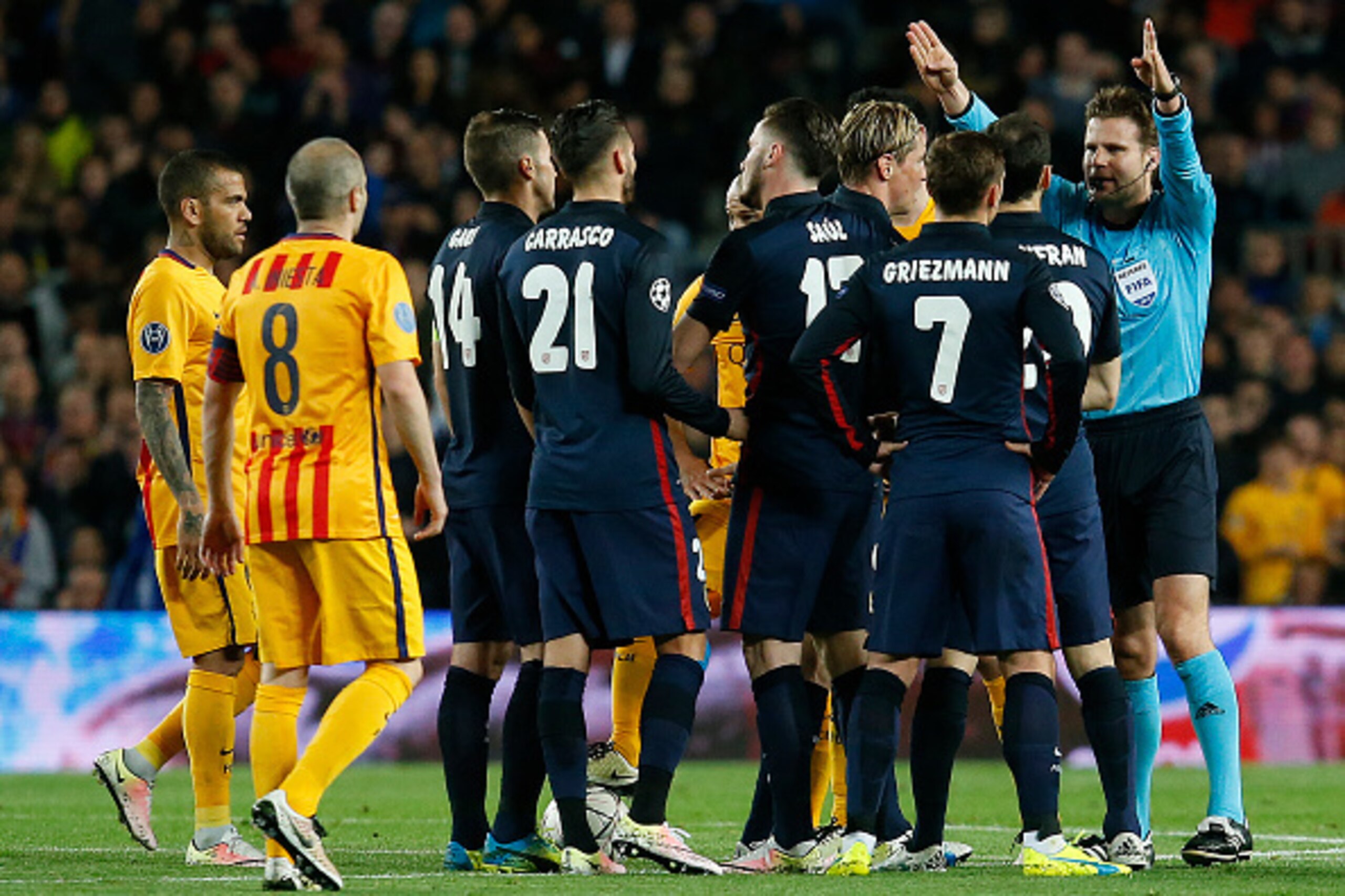 German referee Felix Brych (R) gestures after showing a red card to Atletico Madrid's forward Fernando Torres (4R) during the UEFA Champions League quarter finals first leg football match FC Barcelona vs Atletico de Madrid at the Camp Nou stadium in Barce