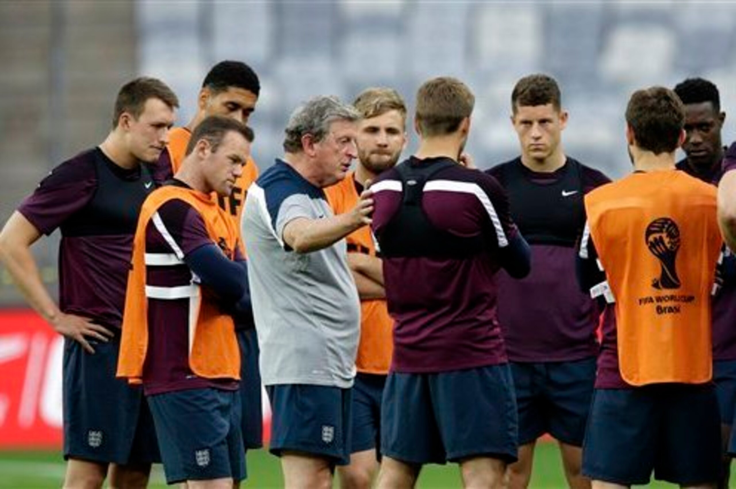 Hodgson addresses a group of England players, including Shaw.