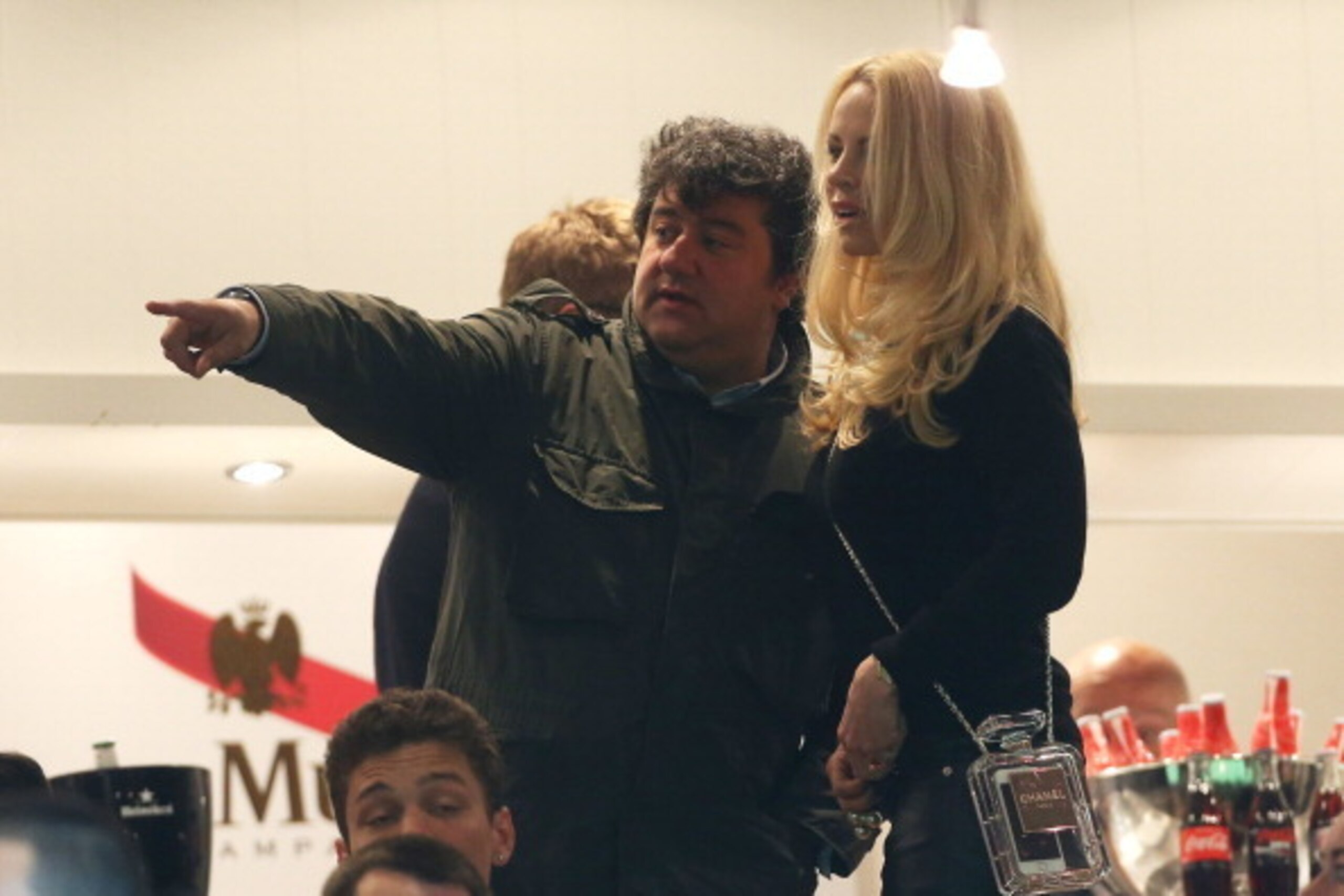 PARIS, FRANCE - MAY 7: Zlatan's agent Mino Raiola and Zlatan's wife Helena Seger Ibrahimovic, holding a Chanel Perfume Bottle Clutch attend the french Ligue 1 match between Paris Saint-Germain FC and Stade Rennais FC at Parc des Princes stadium on May 7, 
